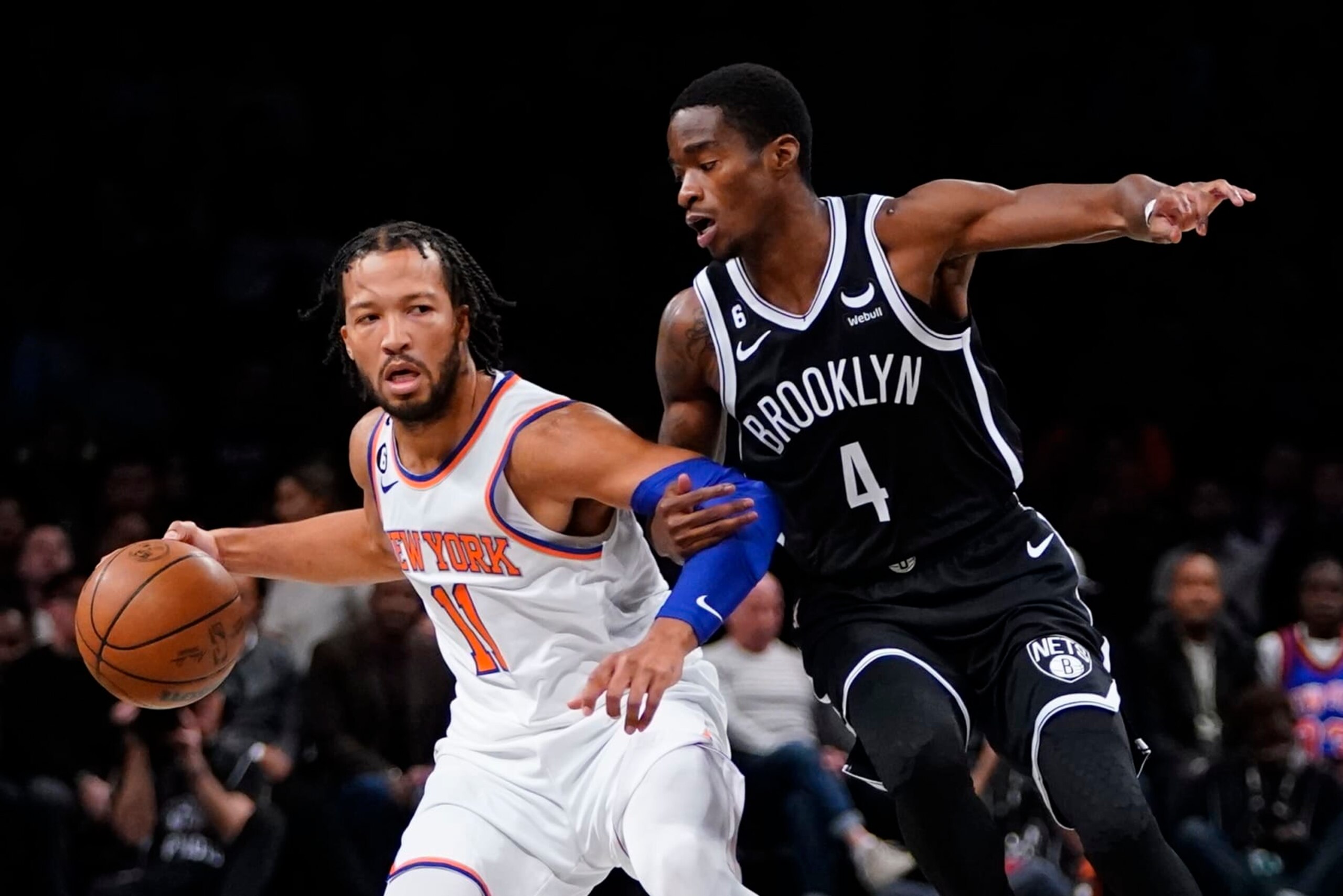 Brooklyn Nets' Edmond Sumner (4) defends New York Knicks' Jalen Brunson (11) during the first half of an NBA basketball game Wednesday, Nov. 9, 2022, in New York. (AP Photo/Frank Franklin II)