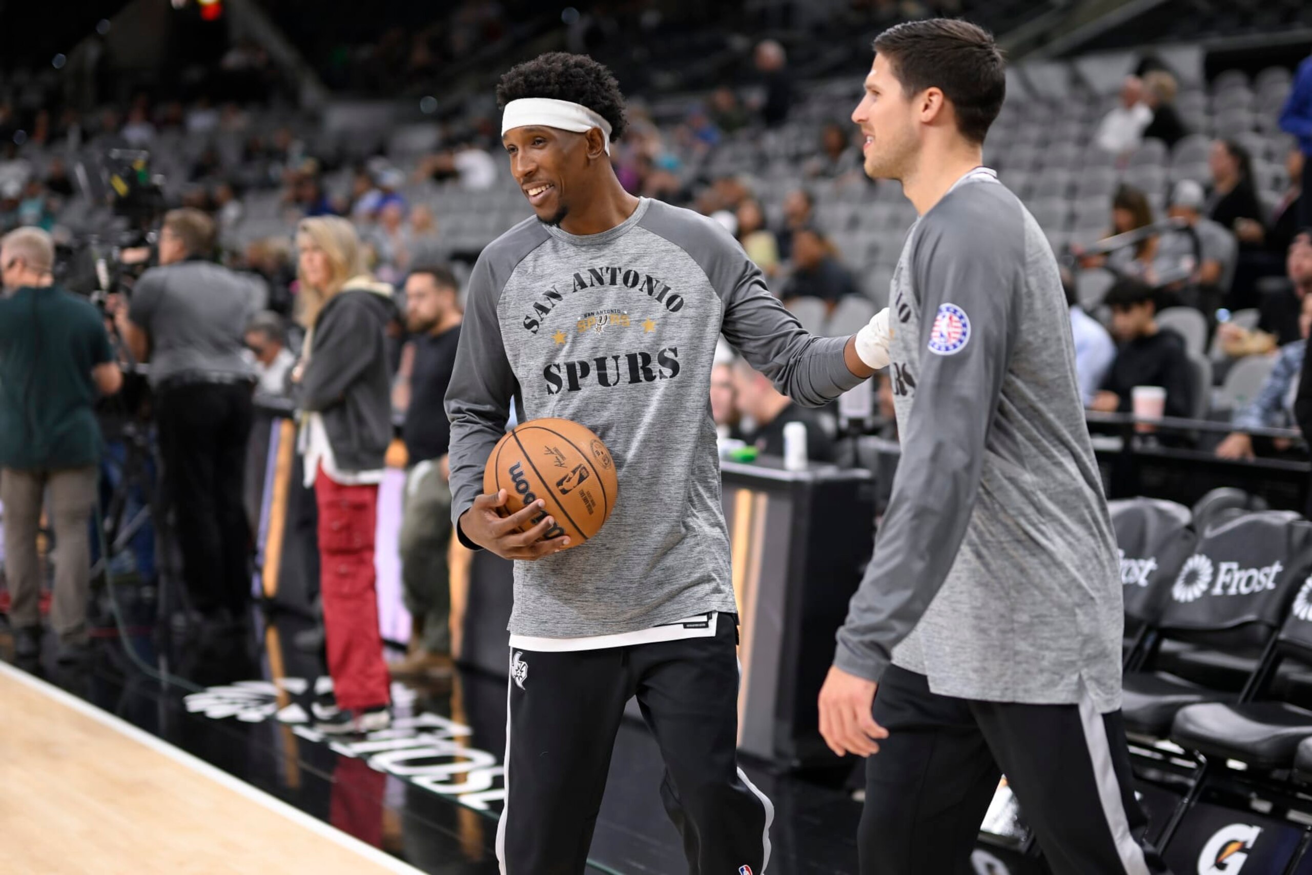 San Antonio Spurs' Josh Richardson and Doug McDermott, right, warm up before an NBA basketball game against the Memphis Grizzlies, Wednesday, Nov. 9, 2022, in San Antonio. (AP Photo/Darren Abate)