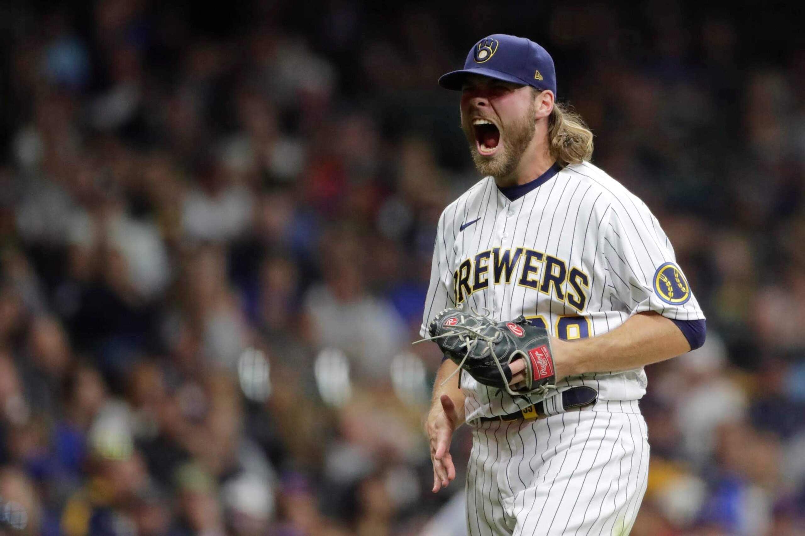 Milwaukee Brewers' Corbin Burnes reacts after striking out a batter during the seventh inning of a baseball game against the New York Mets Saturday, Sept. 25, 2021, in Milwaukee. (AP Photo/Aaron Gash)