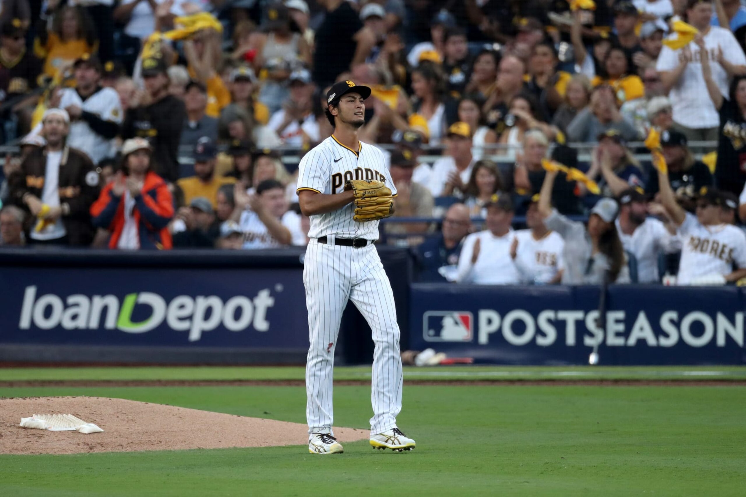 SAN DIEGO, CALIFORNIA - OCTOBER 18: Yu Darvish #11 of the San Diego Padres reacts after a pitch during the second inning against the Philadelphia Phillies in game one of the National League Championship Series at PETCO Park on October 18, 2022 in San Diego, California. (Photo by Denis Poroy/Getty Images)