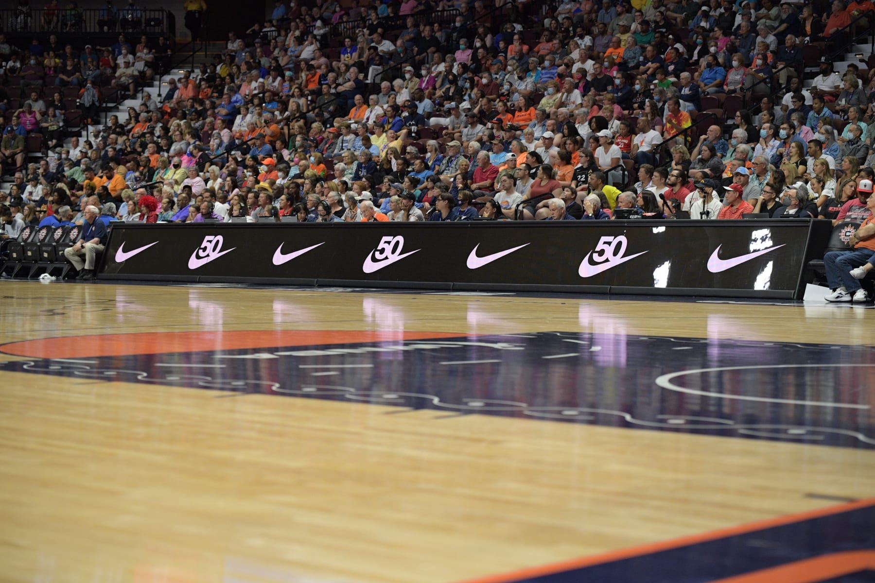 UNCASVILLE, CT - JULY 17: Nike logos celebrating the 50th anniversary of the Swoosh are seen on the scorer's table during the WNBA game between the Las Vegas Aces and the Connecticut Sun on July 17, 2022, at Mohegan Sun Arena in Uncasville, CT. (Photo by Erica Denhoff/Icon Sportswire via Getty Images)