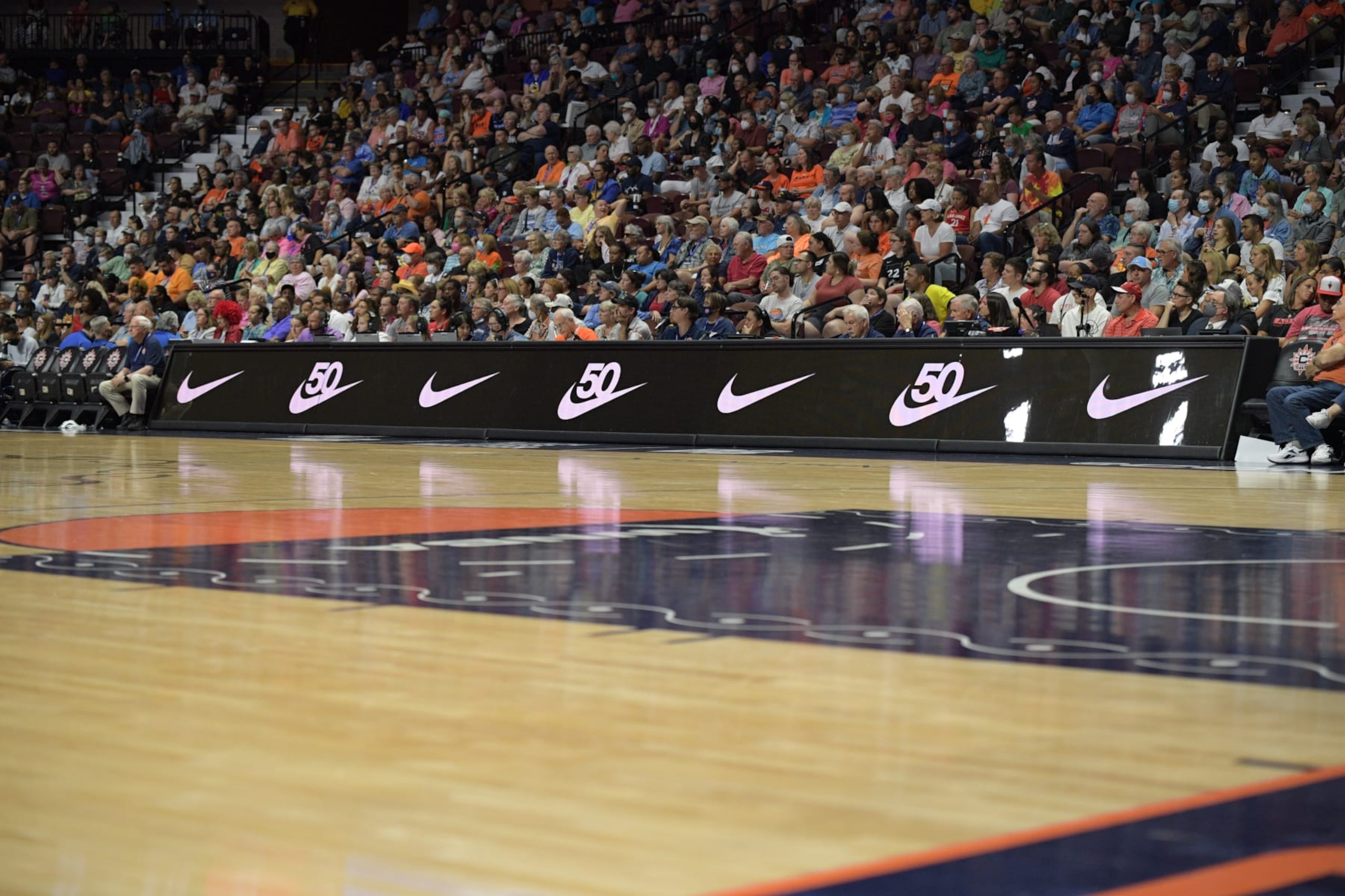 UNCASVILLE, CT - JULY 17: Nike logos celebrating the 50th anniversary of the Swoosh are seen on the scorer's table during the WNBA game between the Las Vegas Aces and the Connecticut Sun on July 17, 2022, at Mohegan Sun Arena in Uncasville, CT. (Photo by Erica Denhoff/Icon Sportswire via Getty Images) UNCASVILLE, CT - JULY 17: Nike logos celebrating the 50th anniversary of the Swoosh are seen on the scorer's table during the WNBA game between the Las Vegas Aces and the Connecticut Sun on July 17, 2022, at Mohegan Sun Arena in Uncasville, CT. (Photo by Erica Denhoff/Icon Sportswire via Getty Images)
