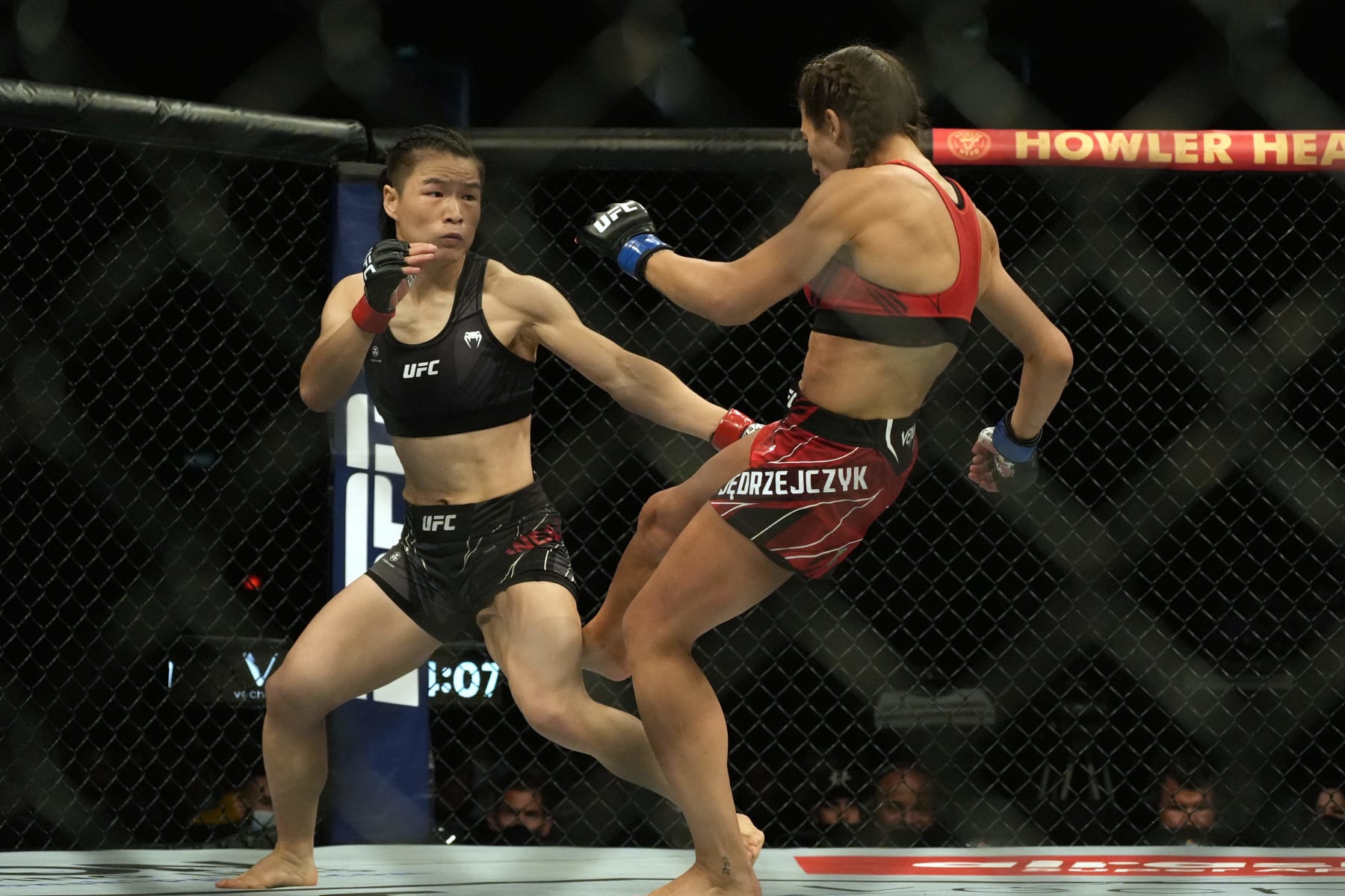 Zhang Weili of China (L) competes with Joanna Jedrzejczyk of Poland in the womens strawweight bout during the Ultimate Fighting Championship (UFC) 275 event in Singapore on June 12, 2022. (Photo by NICHOLAS YEO / AFP) (Photo by NICHOLAS YEO/AFP via Getty Images)