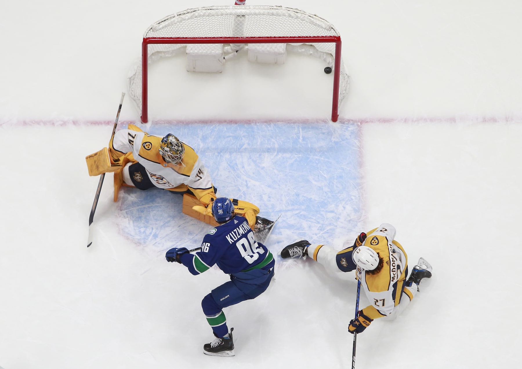Nashville Predators goaltender Juuse Saros is scored on by Vancouver Canucks forward Andrei Kuzmenko. 