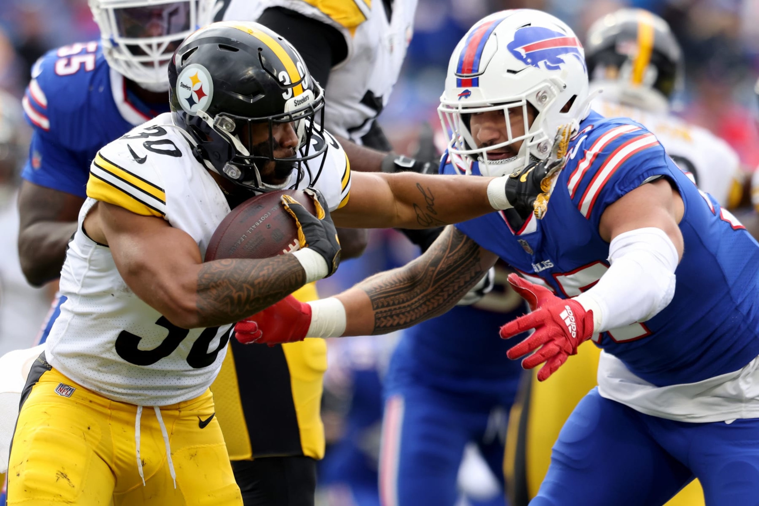 ORCHARD PARK, NEW YORK - OCTOBER 09: Jaylen Warren #30 of the Pittsburgh Steelers is tackled by AJ Epenesa #57 of the Buffalo Bills during the fourth quarter at Highmark Stadium on October 09, 2022 in Orchard Park, New York. (Photo by Bryan Bennett/Getty Images)