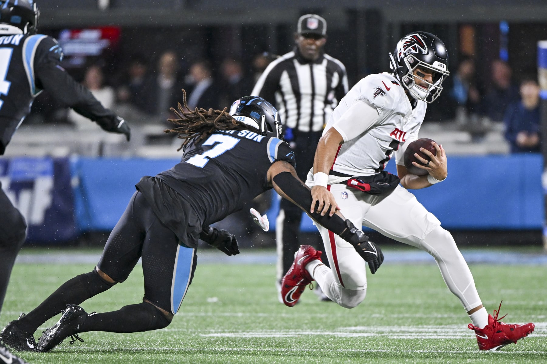 CHARLOTTE, NORTH CAROLINA - NOVEMBER 10: Shaq Thompson #7 of the Carolina Panthers tackles Marcus Mariota #1 of the Atlanta Falcons during the first quarter at Bank of America Stadium on November 10, 2022 in Charlotte, North Carolina. (Photo by Grant Halverson/Getty Images)