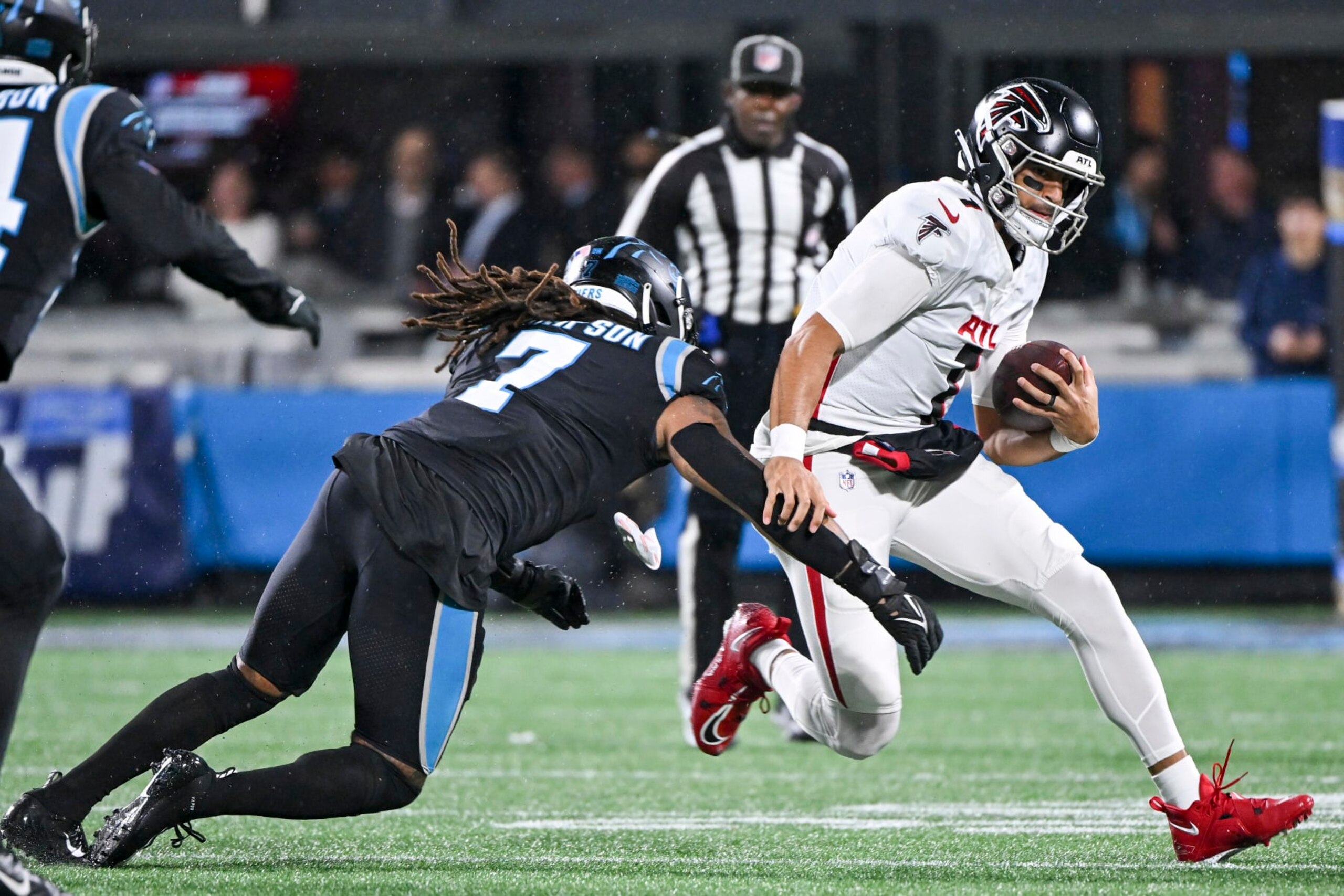 CHARLOTTE, NORTH CAROLINA - NOVEMBER 10: Shaq Thompson #7 of the Carolina Panthers tackles Marcus Mariota #1 of the Atlanta Falcons during the first quarter at Bank of America Stadium on November 10, 2022 in Charlotte, North Carolina. (Photo by Grant Halverson/Getty Images)