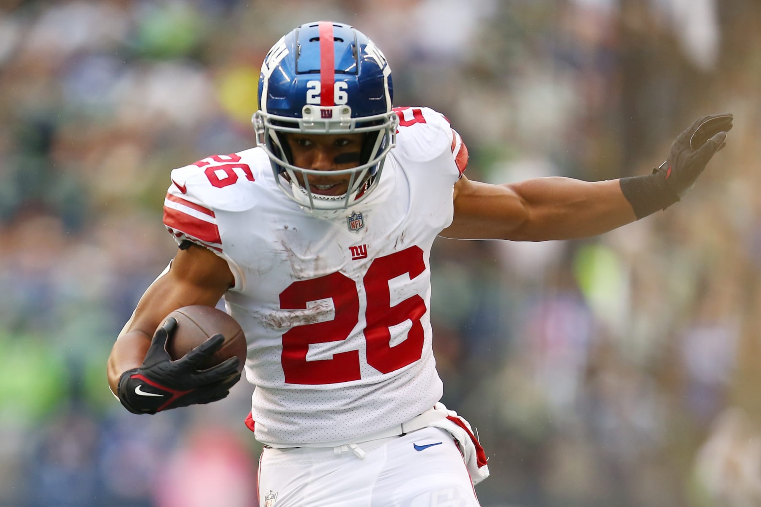 SEATTLE, WASHINGTON - OCTOBER 30: Saquon Barkley #26 of the New York Giants runs against the Seattle Seahawks during the second half at Lumen Field on October 30, 2022 in Seattle, Washington. (Photo by Lindsey Wasson/Getty Images) SEATTLE, WASHINGTON - OCTOBER 30: Saquon Barkley #26 of the New York Giants runs against the Seattle Seahawks during the second half at Lumen Field on October 30, 2022 in Seattle, Washington. (Photo by Lindsey Wasson/Getty Images)