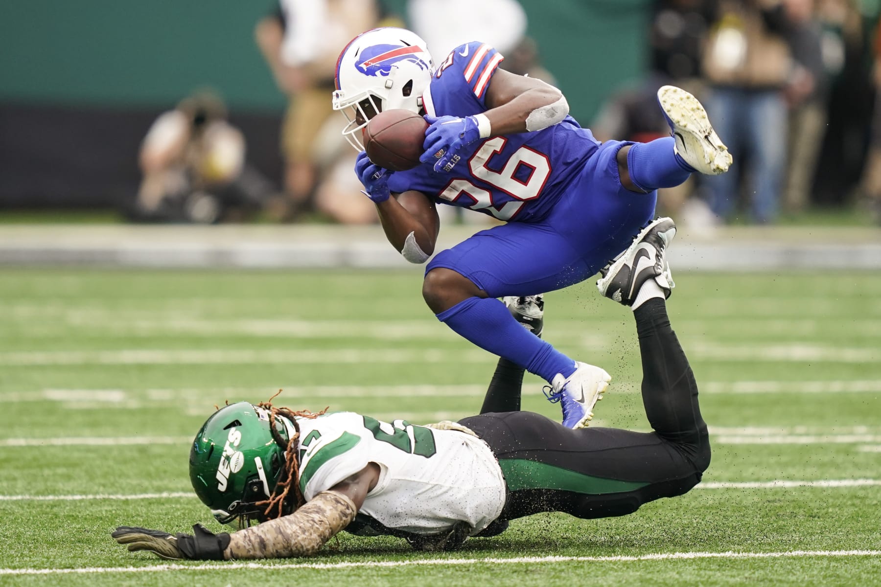 Buffalo Bills running back Devin Singletary (26) catches a pass over New York Jets' C.J. Mosley, bottom, during the first half of an NFL football game, Sunday, Nov. 6, 2022, in East Rutherford, N.J. (AP Photo/John Minchillo)