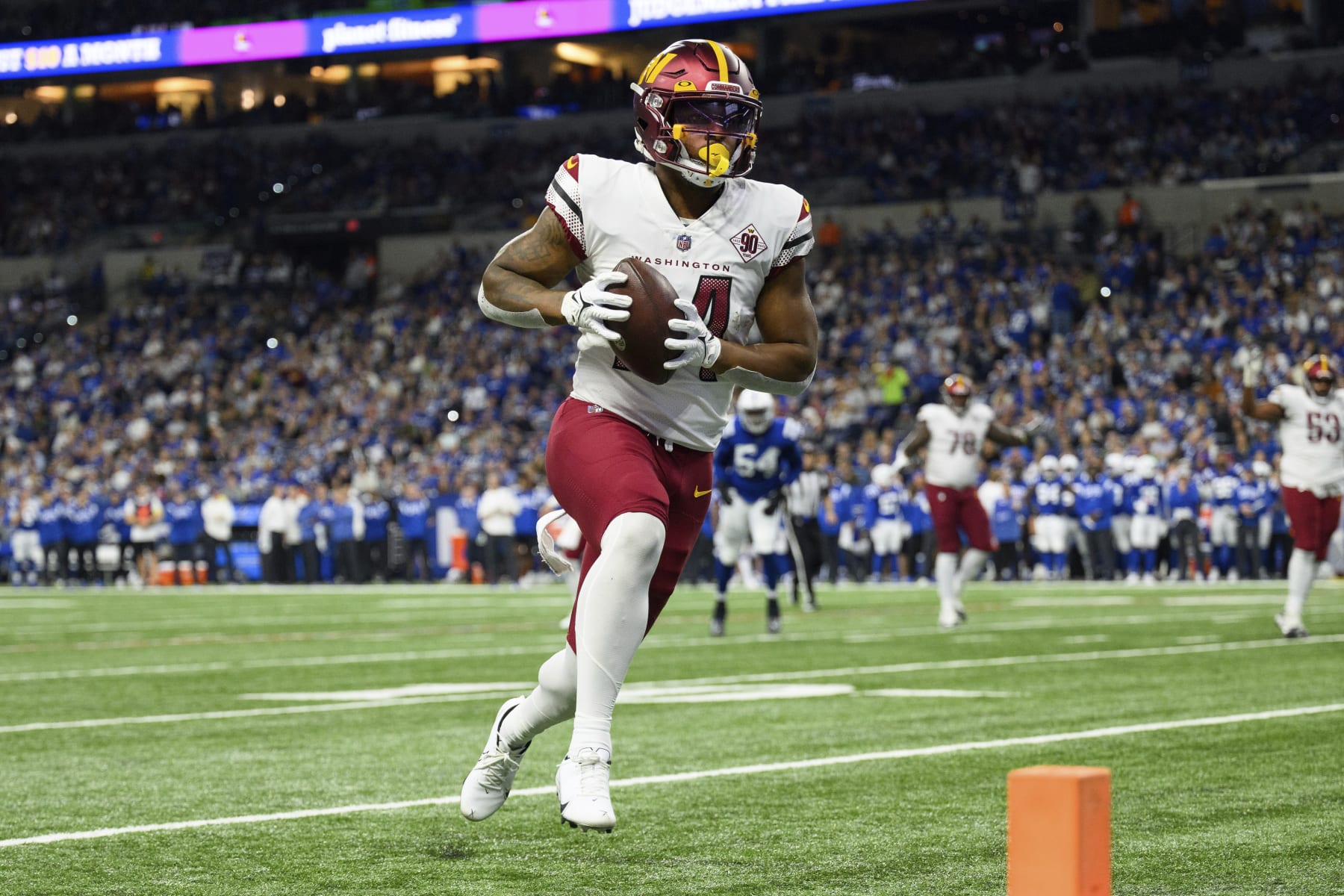 Washington Commanders running back Antonio Gibson (24) scores a touchdown on a run to the outside during an NFL football game against the Indianapolis Colts, Sunday, Oct. 30, 2022, in Indianapolis. (AP Photo/Zach Bolinger)
