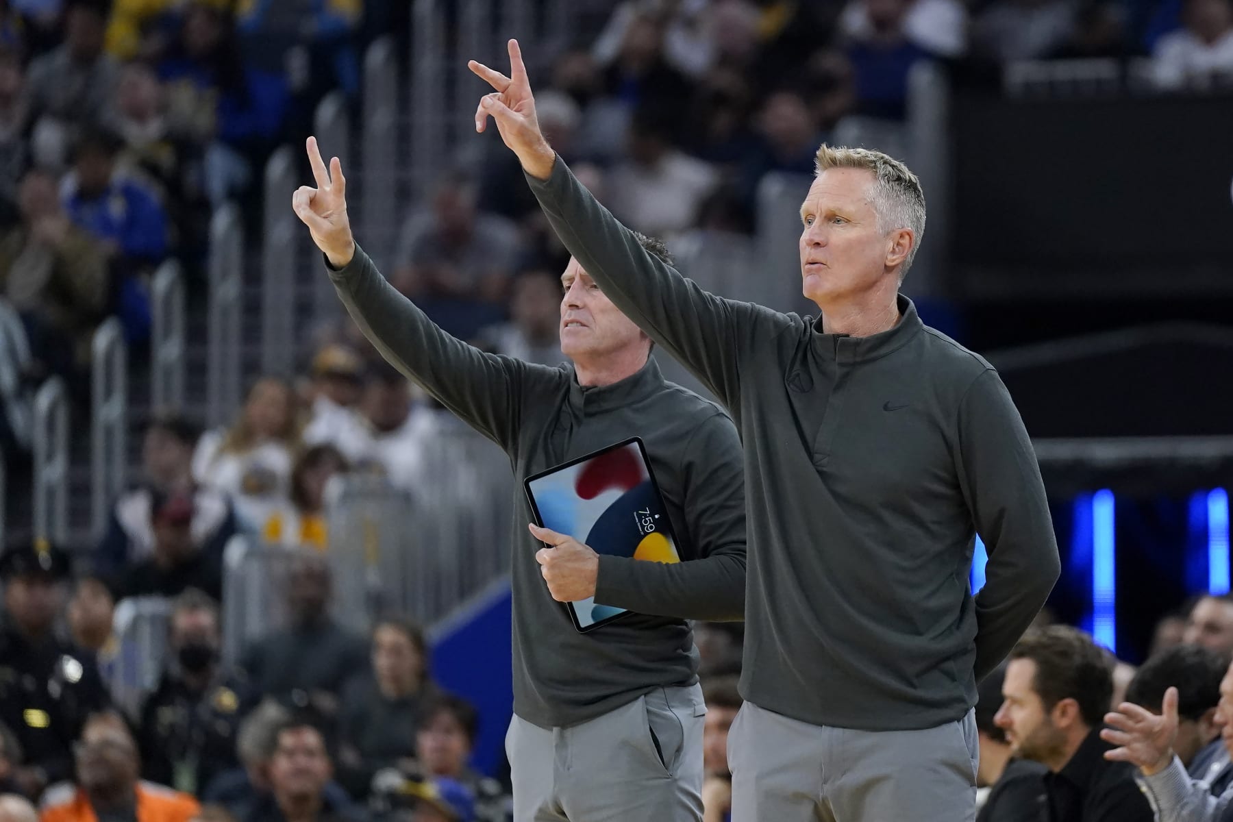 Golden State Warriors head coach Steve Kerr, right, and assistant coach Kenny Atkinson signal toward players during an NBA basketball game against the Miami Heat in San Francisco, Thursday, Oct. 27, 2022. (AP Photo/Jeff Chiu)