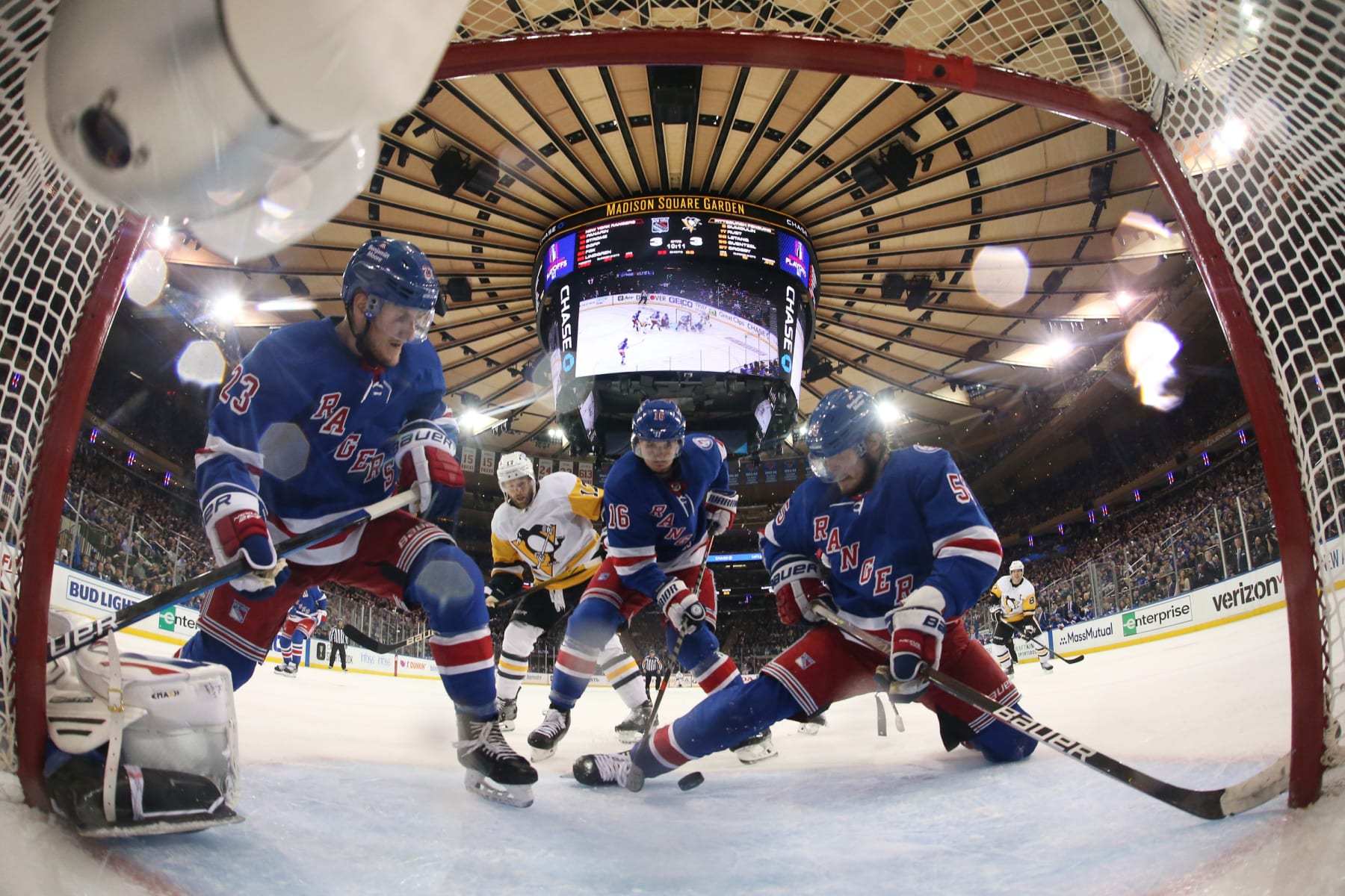 Adam Fox (left) and Ryan Lindgren (right) defend the New York Rangers net. 