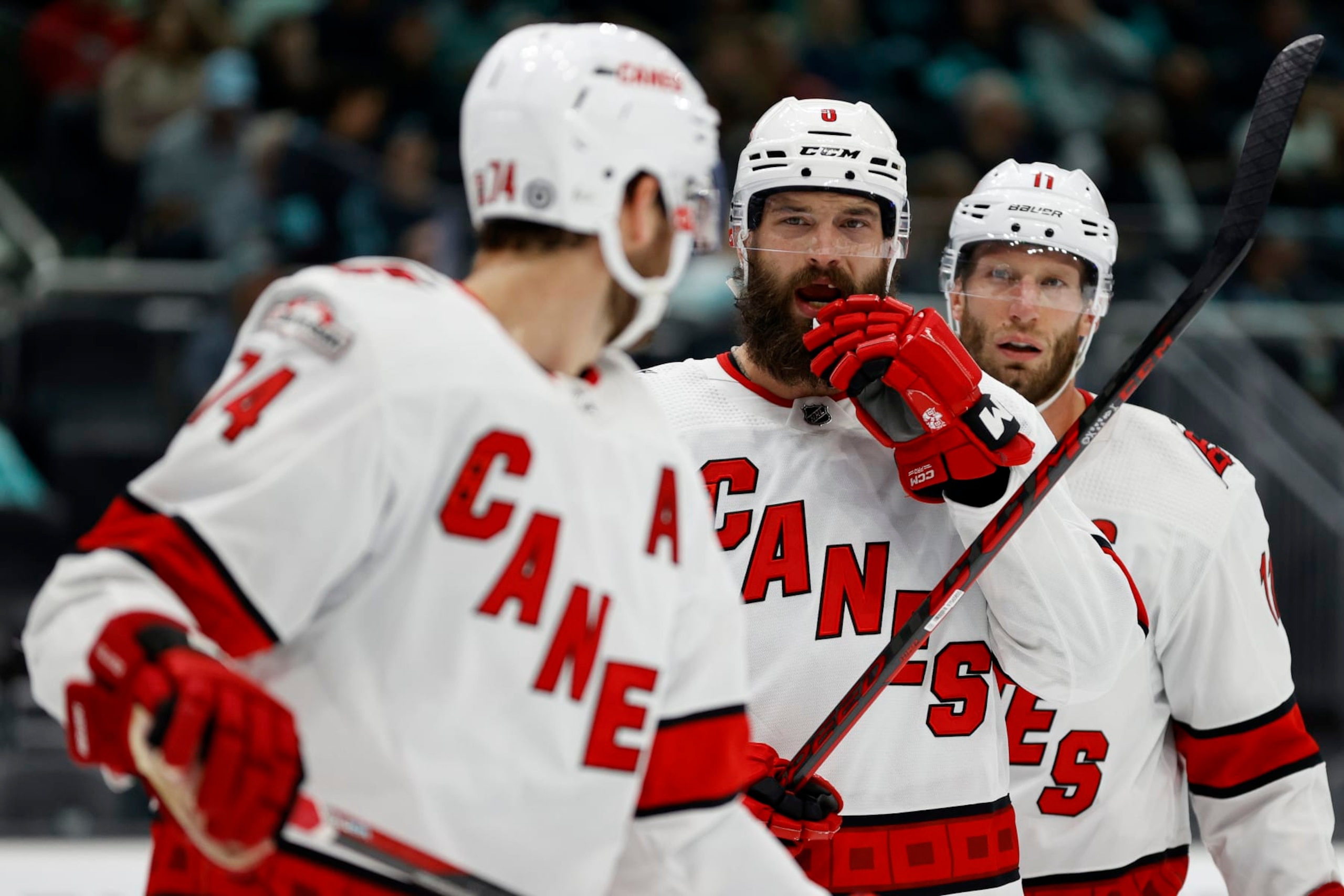 Blueliners Jaccob Slavin (No. 74, foreground) and Brent Burns (center) of the Carolina Hurricanes. 