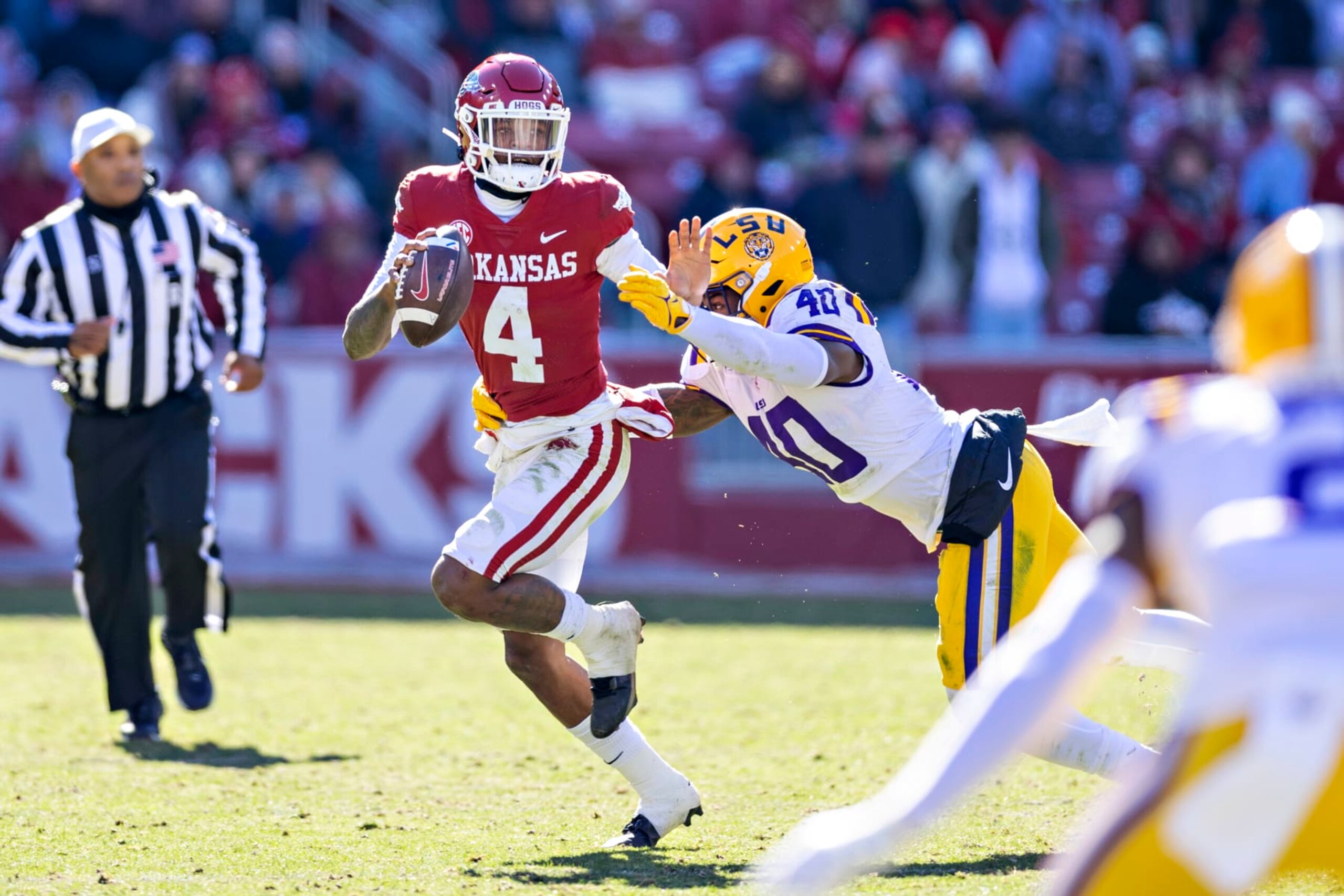 FAYETTEVILLE, ARKANSAS - NOVEMBER 12: Malik Hornsby #4 of the Arkansas Razorbacks is tackled in the second half by Harold Perkins Jr. #40 of the LSU Tigers at Donald W. Reynolds Razorback Stadium on November 12, 2022 in Fayetteville, Arkansas. The Tigers defeated the Razorbacks 13-10.  (Photo by Wesley Hitt/Getty Images)