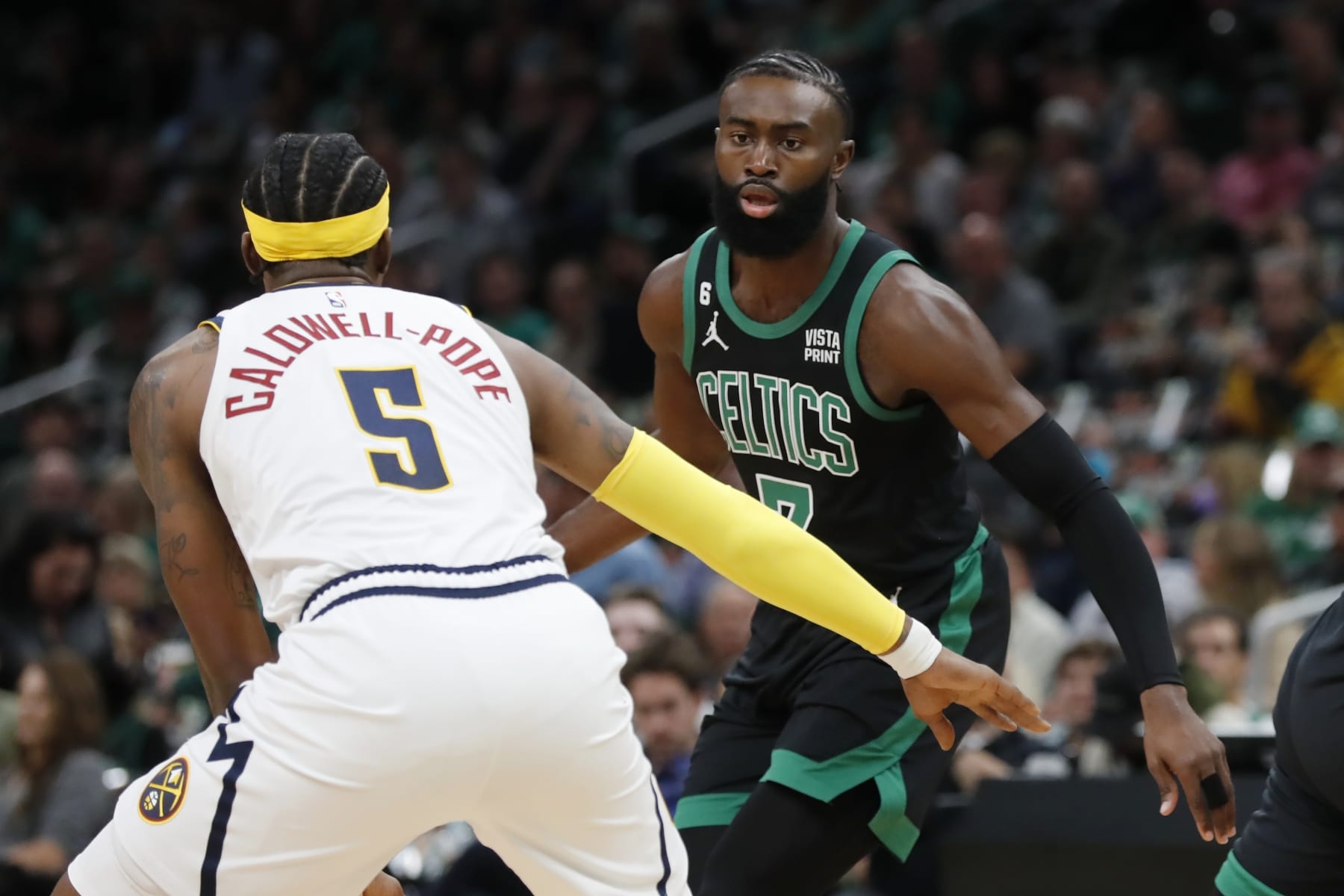 Denver Nuggets' Kentavious Caldwell-Pope (5) defends against Boston Celtics' Jaylen Brown (7) during the first half of an NBA basketball game, Friday, Nov. 11, 2022, in Boston. (AP Photo/Michael Dwyer)
