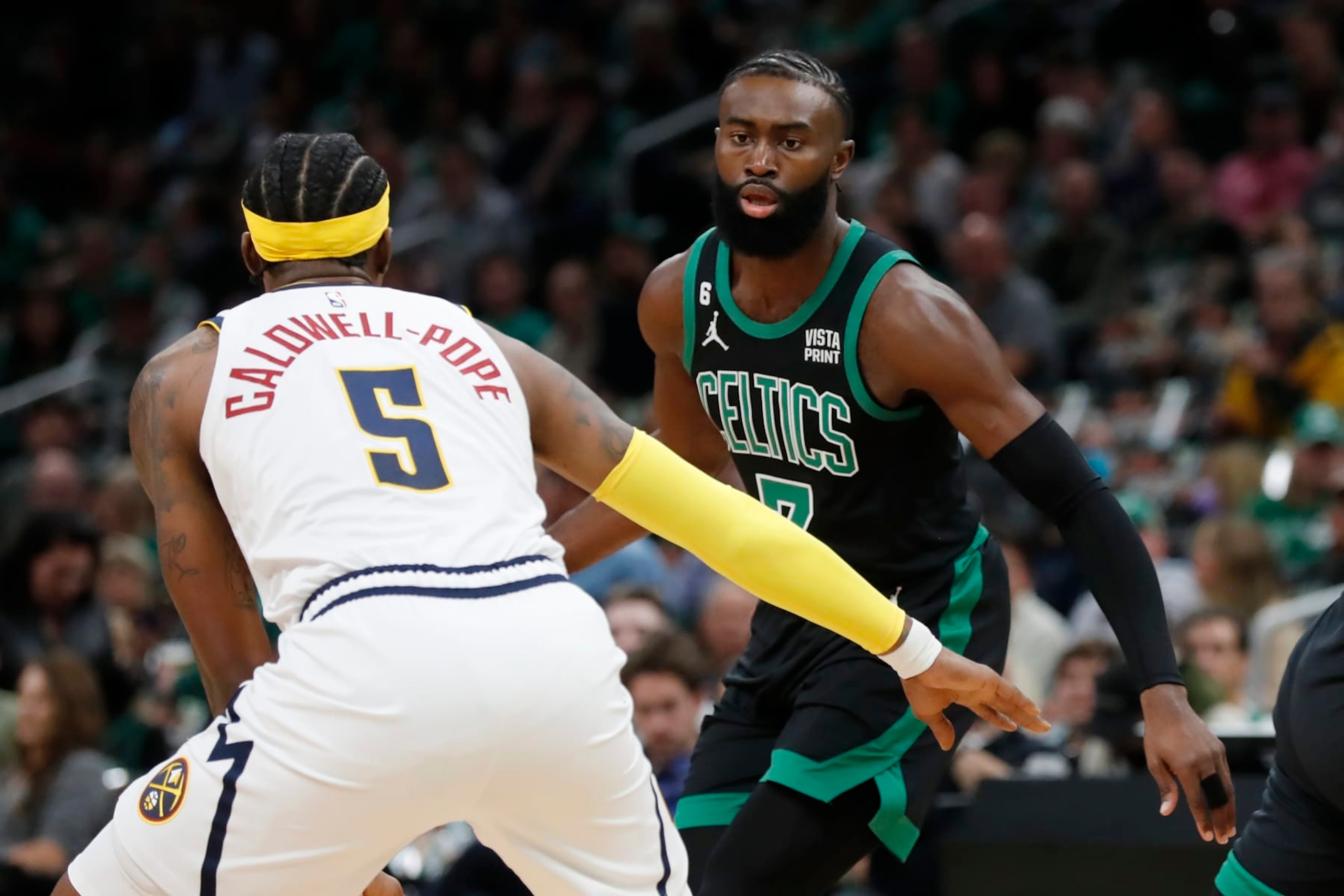 Denver Nuggets' Kentavious Caldwell-Pope (5) defends against Boston Celtics' Jaylen Brown (7) during the first half of an NBA basketball game, Friday, Nov. 11, 2022, in Boston. (AP Photo/Michael Dwyer) Denver Nuggets' Kentavious Caldwell-Pope (5) defends against Boston Celtics' Jaylen Brown (7) during the first half of an NBA basketball game, Friday, Nov. 11, 2022, in Boston. (AP Photo/Michael Dwyer)
