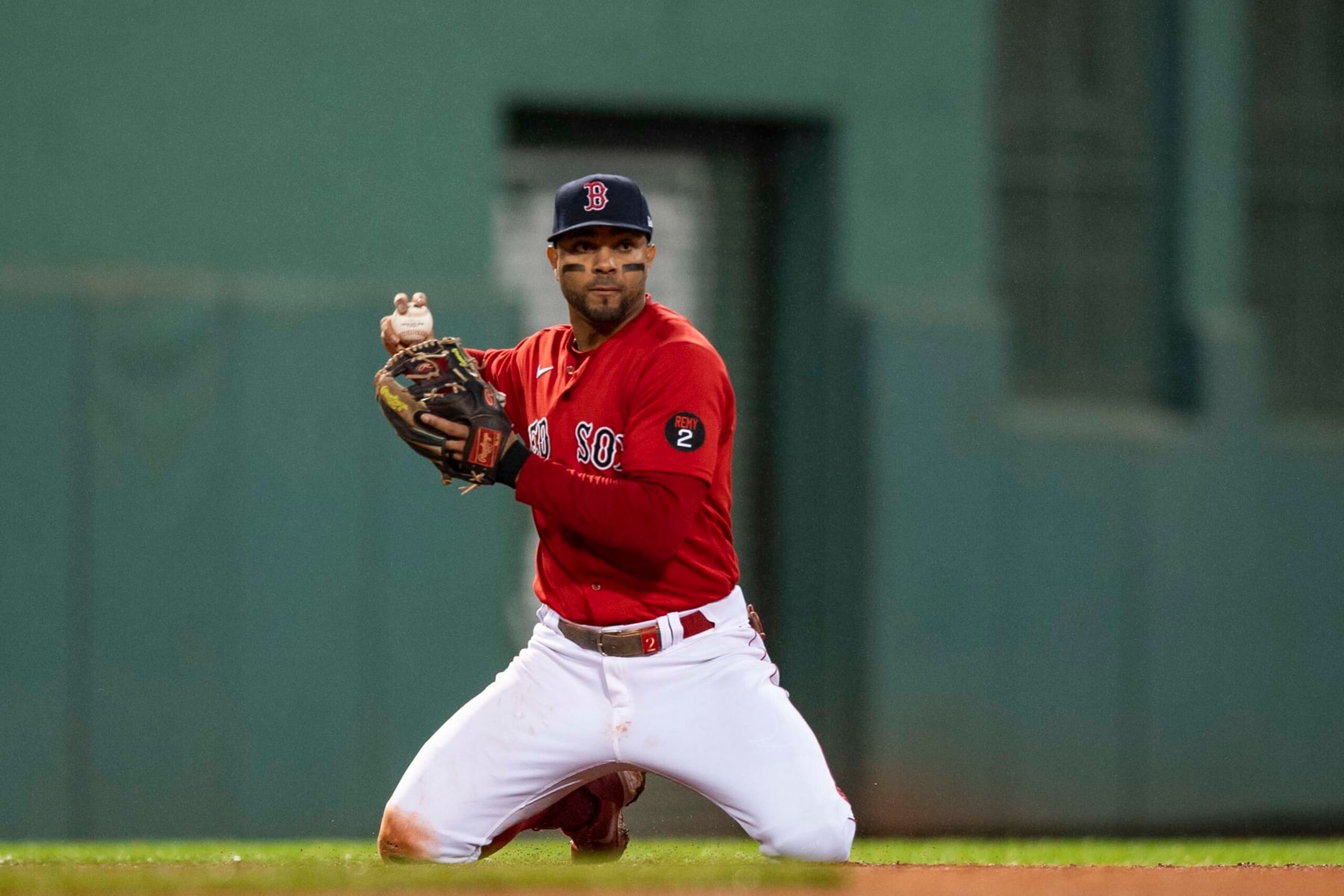 BOSTON, MA - OCTOBER 5: Xander Bogaerts #2 of the Boston Red Sox throws from his knees to begin a double play during the sixth inning of a game against the Tampa Bay Rays on October 5, 2022 at Fenway Park in Boston, Massachusetts. (Photo by Billie Weiss/Boston Red Sox/Getty Images)