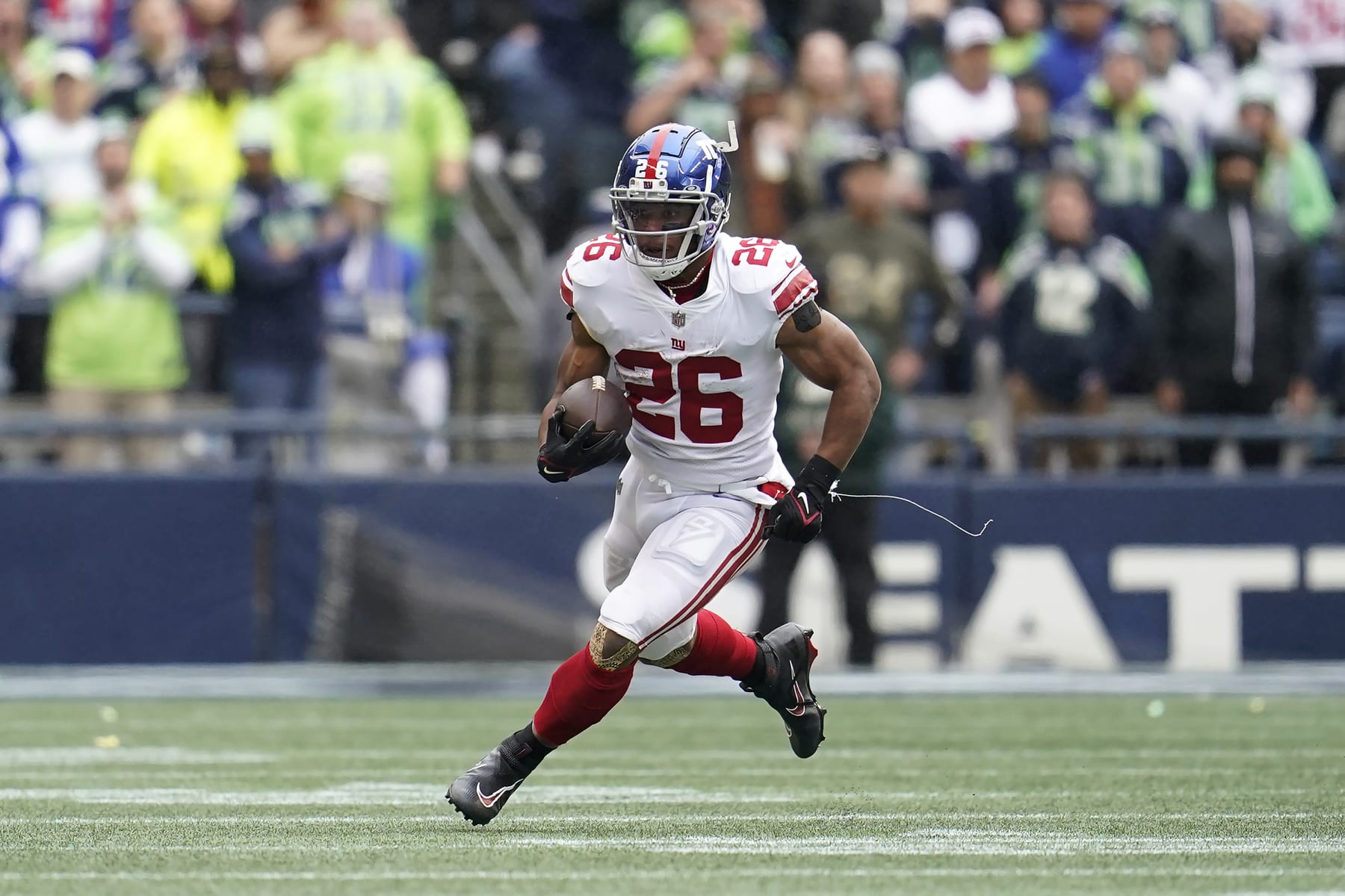 New York Giants running back Saquon Barkley (26) runs against the Seattle Seahawks during the first half of an NFL football game in Seattle, Sunday, Oct. 30, 2022. (AP Photo/Marcio Jose Sanchez)