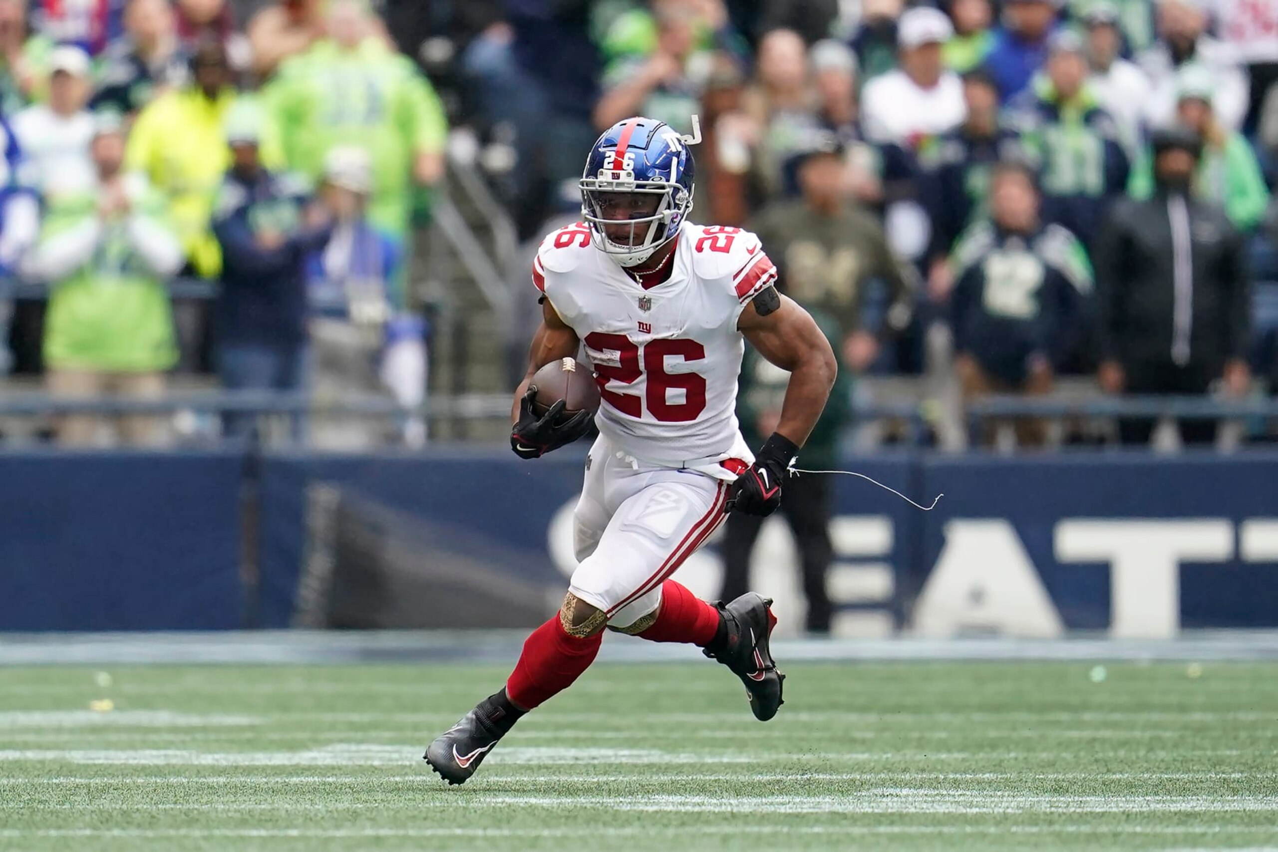 New York Giants running back Saquon Barkley (26) runs against the Seattle Seahawks during the first half of an NFL football game in Seattle, Sunday, Oct. 30, 2022. (AP Photo/Marcio Jose Sanchez)