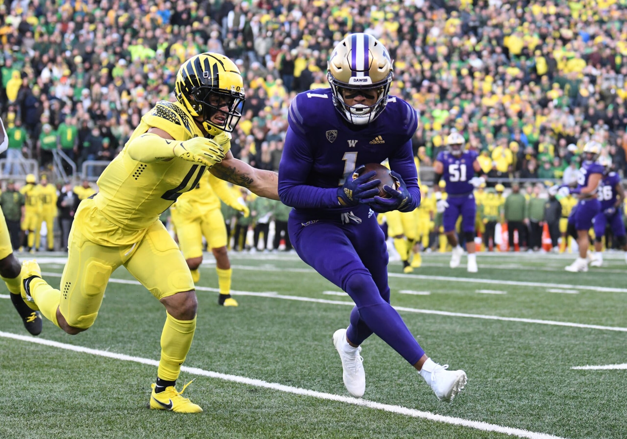 EUGENE, OR - NOVEMBER 12: Washington Huskies wide receiver Rome Odunze (1) runs after the catch against Oregon Ducks defensive back Bennett Williams (4) during a PAC-12 conference college football game between the Washington Huskies and Oregon Ducks on November 12, 2022 at Autzen Stadium in Eugene, Oregon. (Photo by Brian Murphy/Icon Sportswire via Getty Images) EUGENE, OR - NOVEMBER 12: Washington Huskies wide receiver Rome Odunze (1) runs after the catch against Oregon Ducks defensive back Bennett Williams (4) during a PAC-12 conference college football game between the Washington Huskies and Oregon Ducks on November 12, 2022 at Autzen Stadium in Eugene, Oregon. (Photo by Brian Murphy/Icon Sportswire via Getty Images)