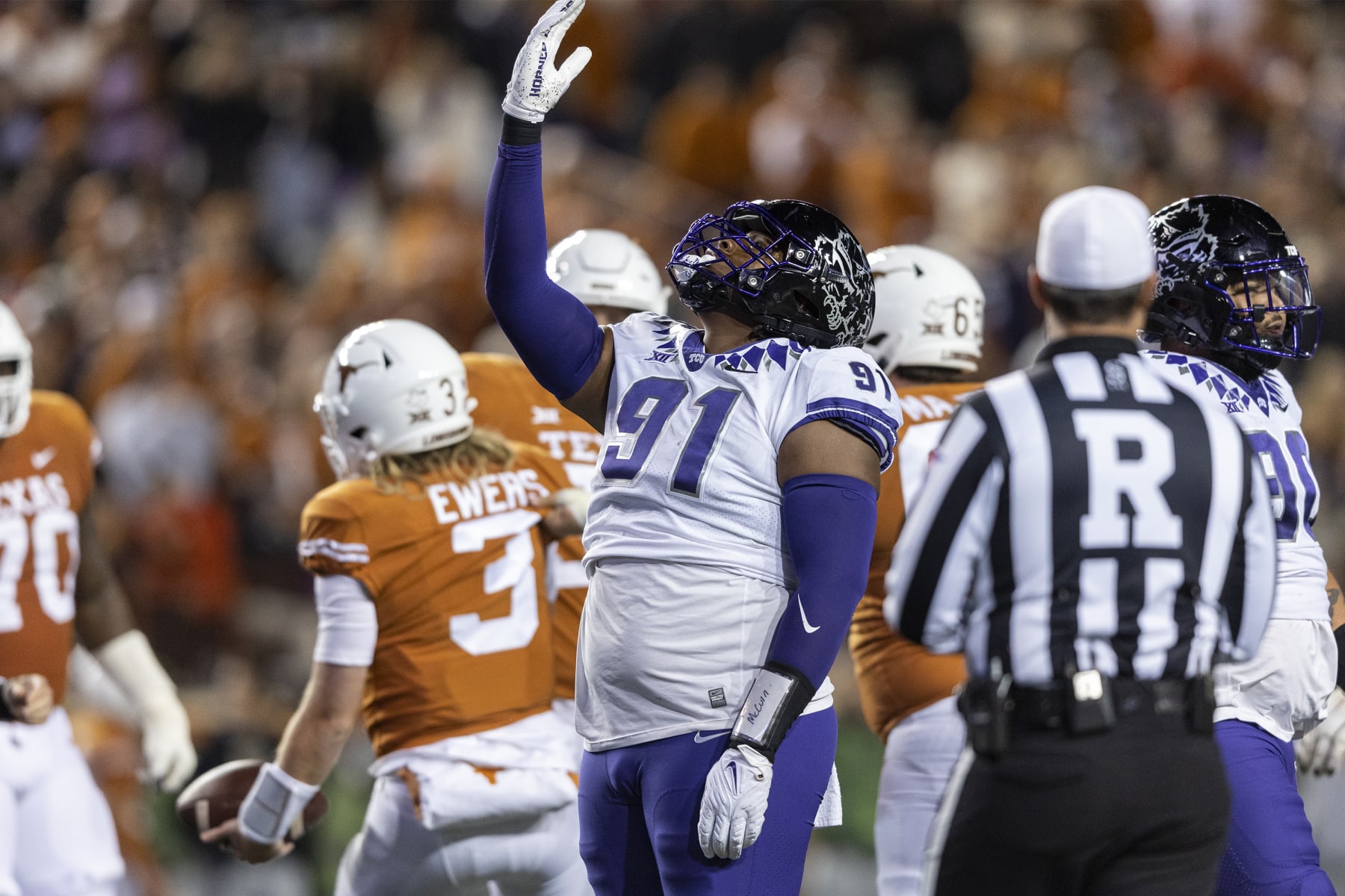TCU defensive lineman Tymon Mitchell (91) celebrates a sack of Texas quarterback Quinn Ewers (3) during the second half of an NCAA college football game Saturday, Nov. 12, 2022, in Austin, Texas. (AP Photo/Stephen Spillman)