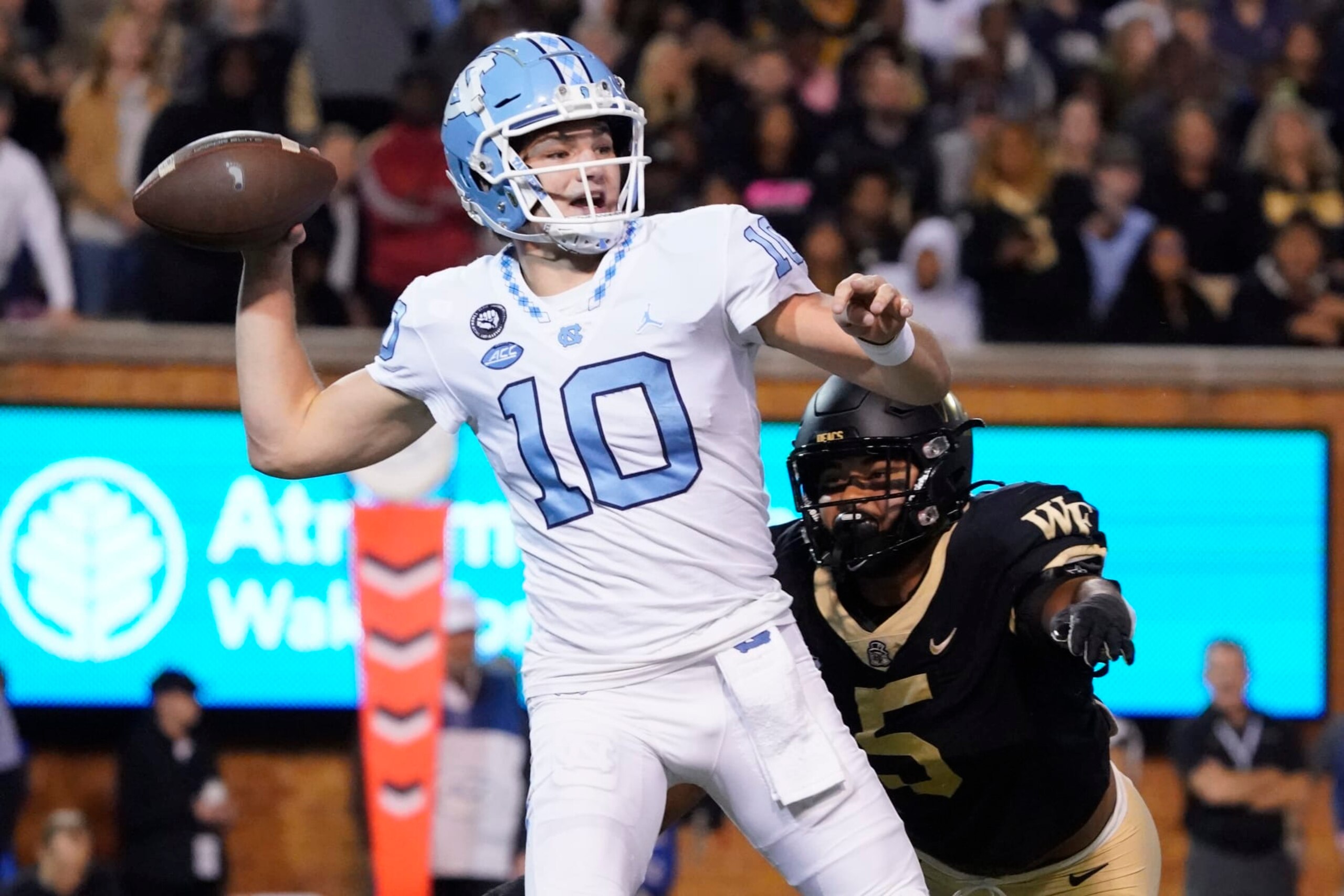 North Carolina quarterback Drake Maye (10) looks to pass as Wake Forest linebacker Ryan Smenda Jr. (5 ) runs towards him during the first half of an NCAA college football game in Winston-Salem, N.C., Saturday, Nov. 12, 2022. (AP Photo/Chuck Burton)