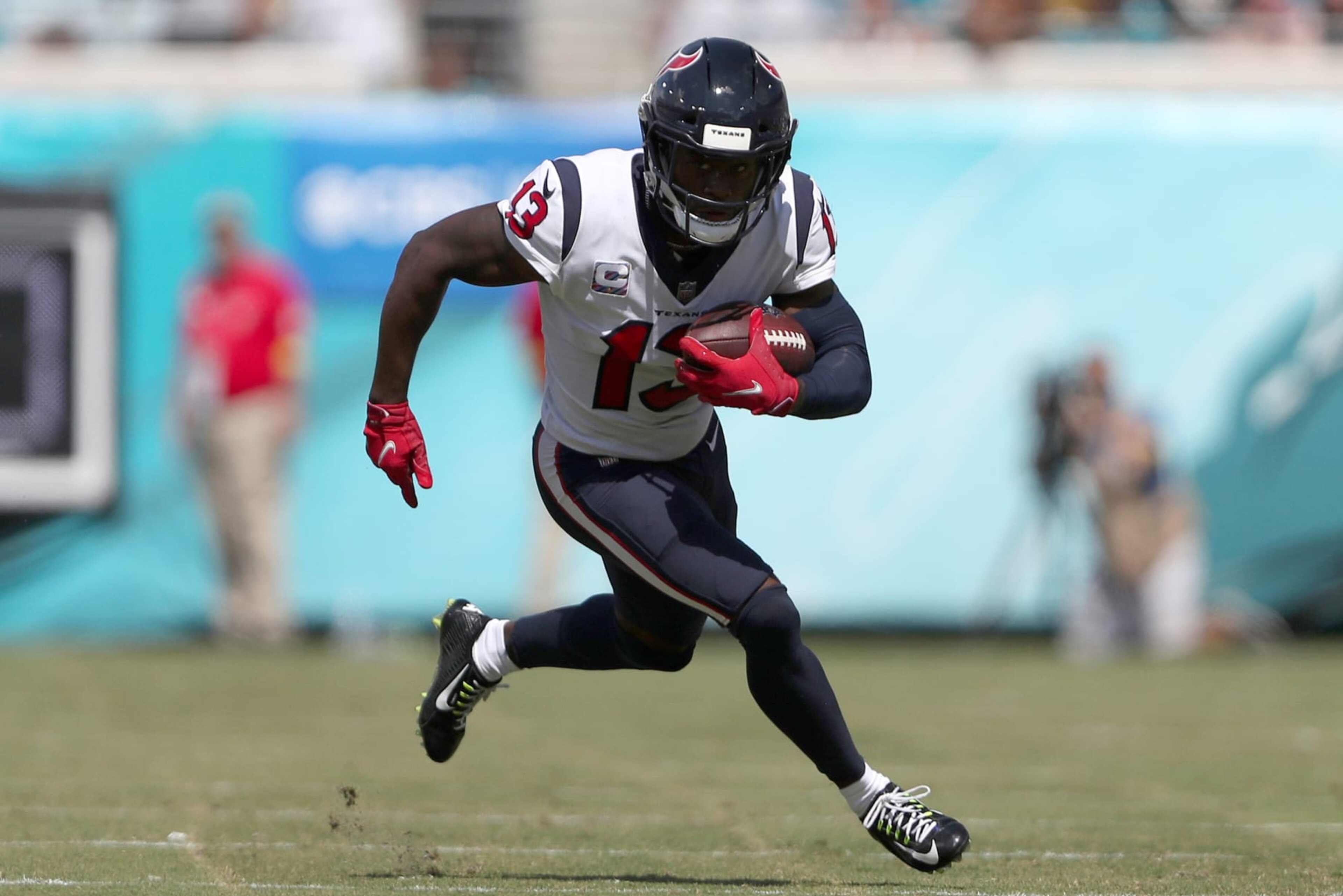 JACKSONVILLE, FLORIDA - OCTOBER 09: Brandin Cooks #13 of the Houston Texans runs for yardage during the first half of the game against the Jacksonville Jaguars at TIAA Bank Field on October 09, 2022 in Jacksonville, Florida. (Photo by Courtney Culbreath/Getty Images)