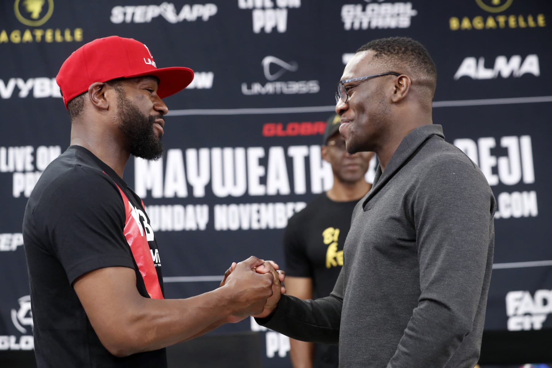 LAS VEGAS, NEVADA - OCTOBER 13: Floyd Mayweather Jr. (L) and Deji Olatunji shake hands during a news conference at the Mayweather Boxing Club on October 13, 2022 in Las Vegas, Nevada. Mayweather is scheduled to fight Olatunji in an exhibition match in Dubai on November 13, 2022.  (Photo by Steve Marcus/Getty Images)