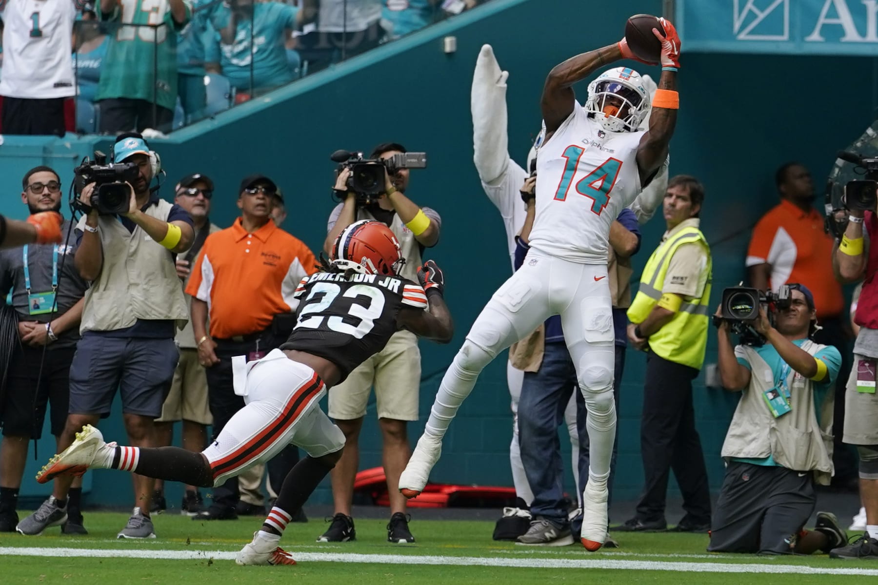 Miami Dolphins wide receiver Trent Sherfield (14) catches a touchdown pass as Cleveland Browns cornerback Martin Emerson Jr. (23) is late with the tackle during the first half of an NFL football game, Sunday, Nov. 13, 2022, in Miami Gardens, Fla. (AP Photo/Lynne Sladky)