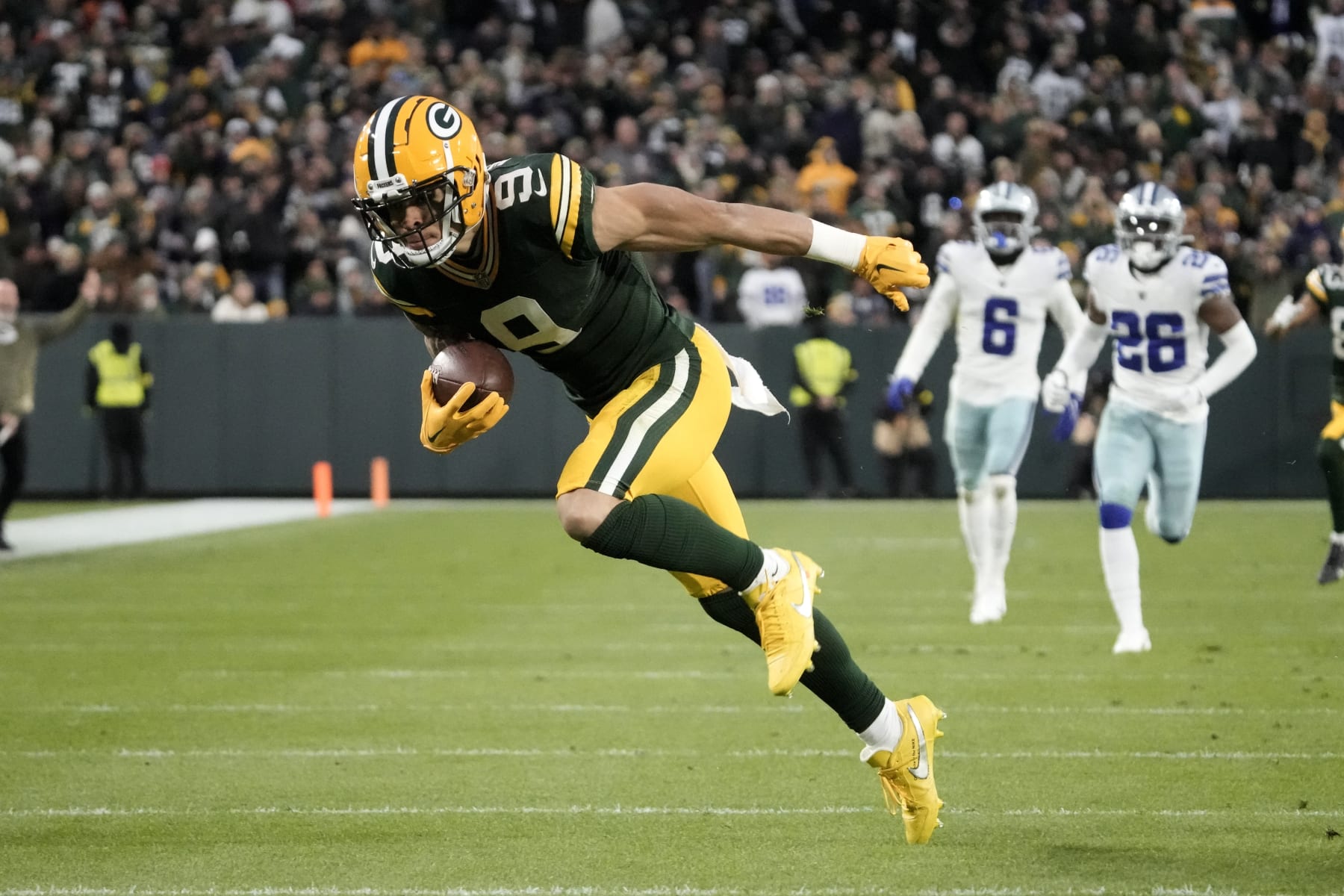 Green Bay Packers wide receiver Christian Watson (9) sprints to the end zone after catching a long pass for a touchdown during the first half of an NFL football game against the Dallas Cowboys Sunday, Nov. 13, 2022, in Green Bay, Wis. (AP Photo/Morry Gash)