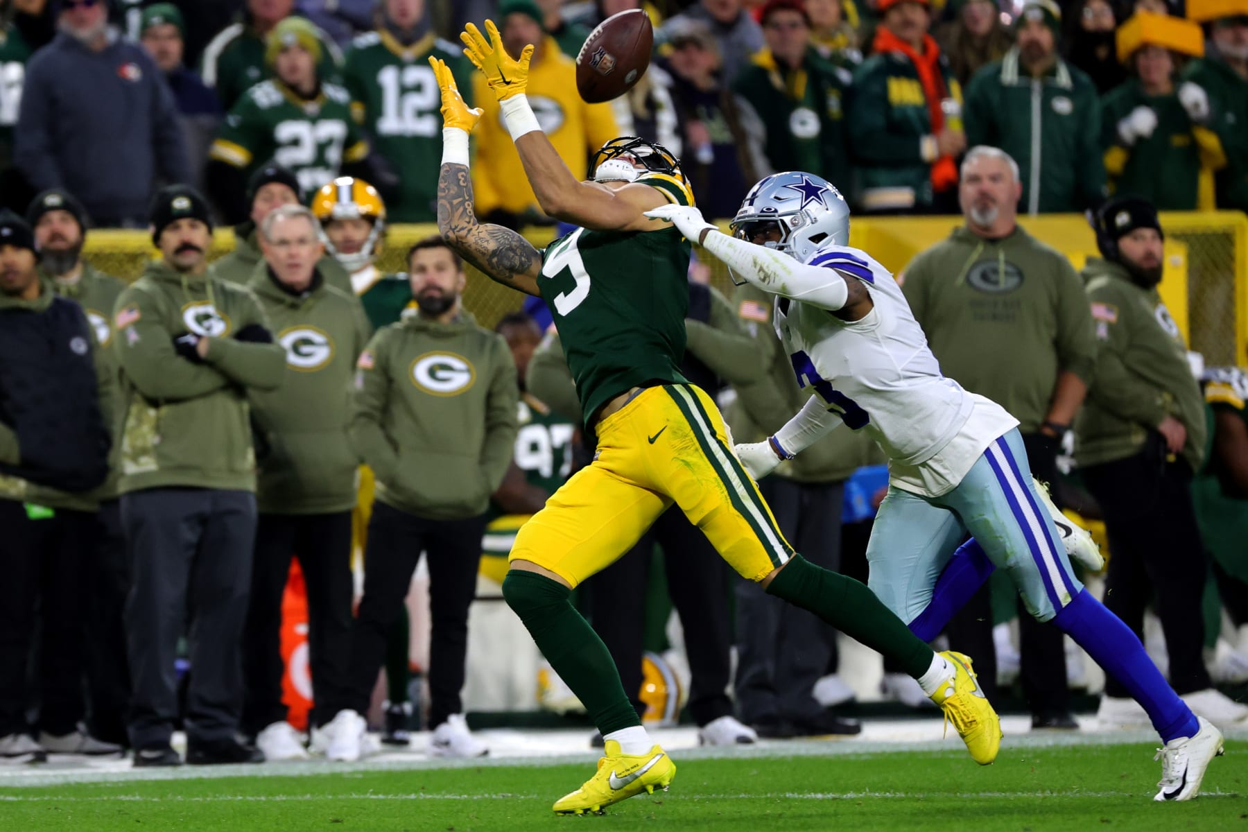 GREEN BAY, WISCONSIN - NOVEMBER 13: Christian Watson #9 of the Green Bay Packers catches touchdown pass over Anthony Brown #3 of the Dallas Cowboys during the second quarter at Lambeau Field on November 13, 2022 in Green Bay, Wisconsin. (Photo by Stacy Revere/Getty Images)