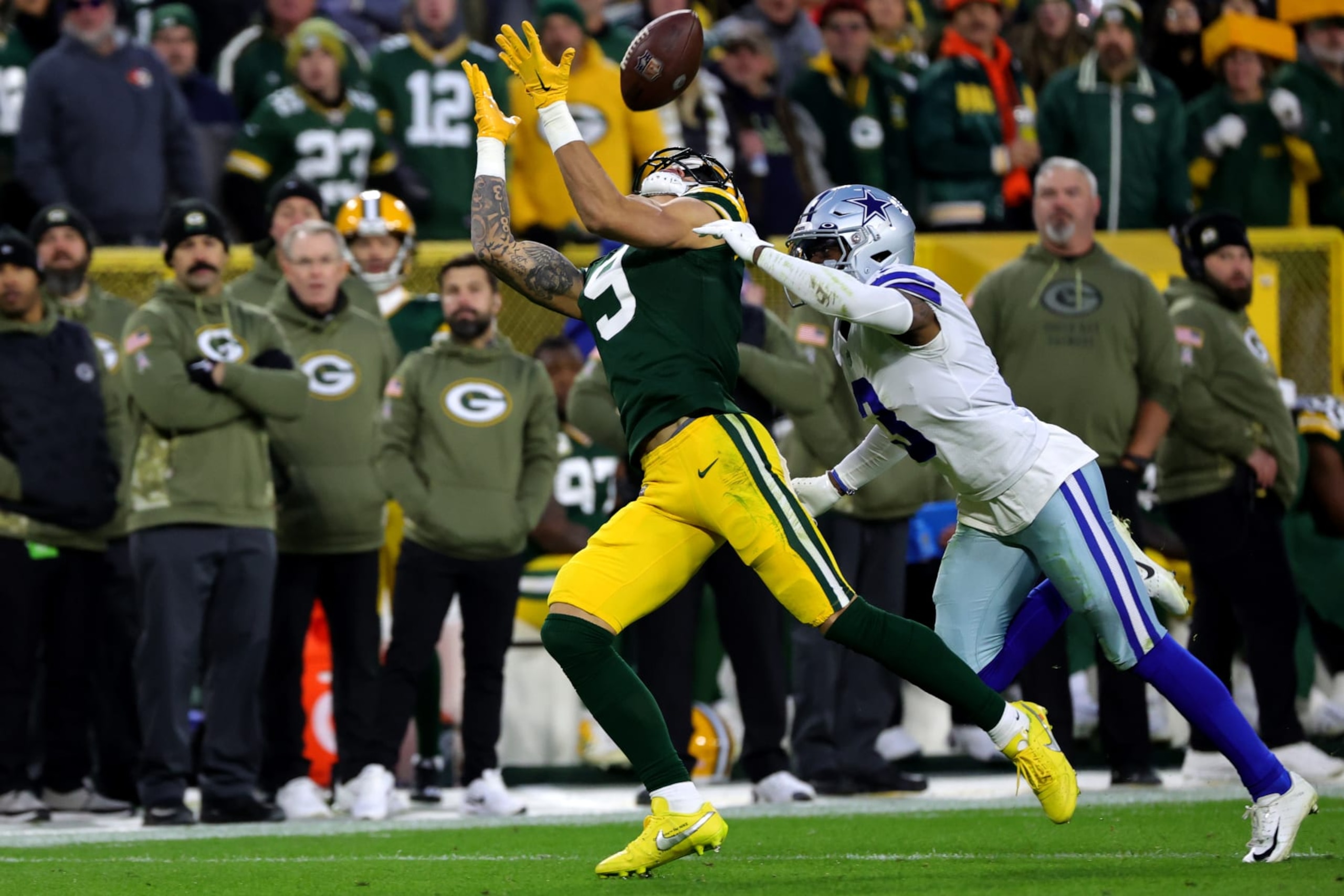 GREEN BAY, WISCONSIN - NOVEMBER 13: Christian Watson #9 of the Green Bay Packers catches touchdown pass over Anthony Brown #3 of the Dallas Cowboys during the second quarter at Lambeau Field on November 13, 2022 in Green Bay, Wisconsin. (Photo by Stacy Revere/Getty Images) GREEN BAY, WISCONSIN - NOVEMBER 13: Christian Watson #9 of the Green Bay Packers catches touchdown pass over Anthony Brown #3 of the Dallas Cowboys during the second quarter at Lambeau Field on November 13, 2022 in Green Bay, Wisconsin. (Photo by Stacy Revere/Getty Images)