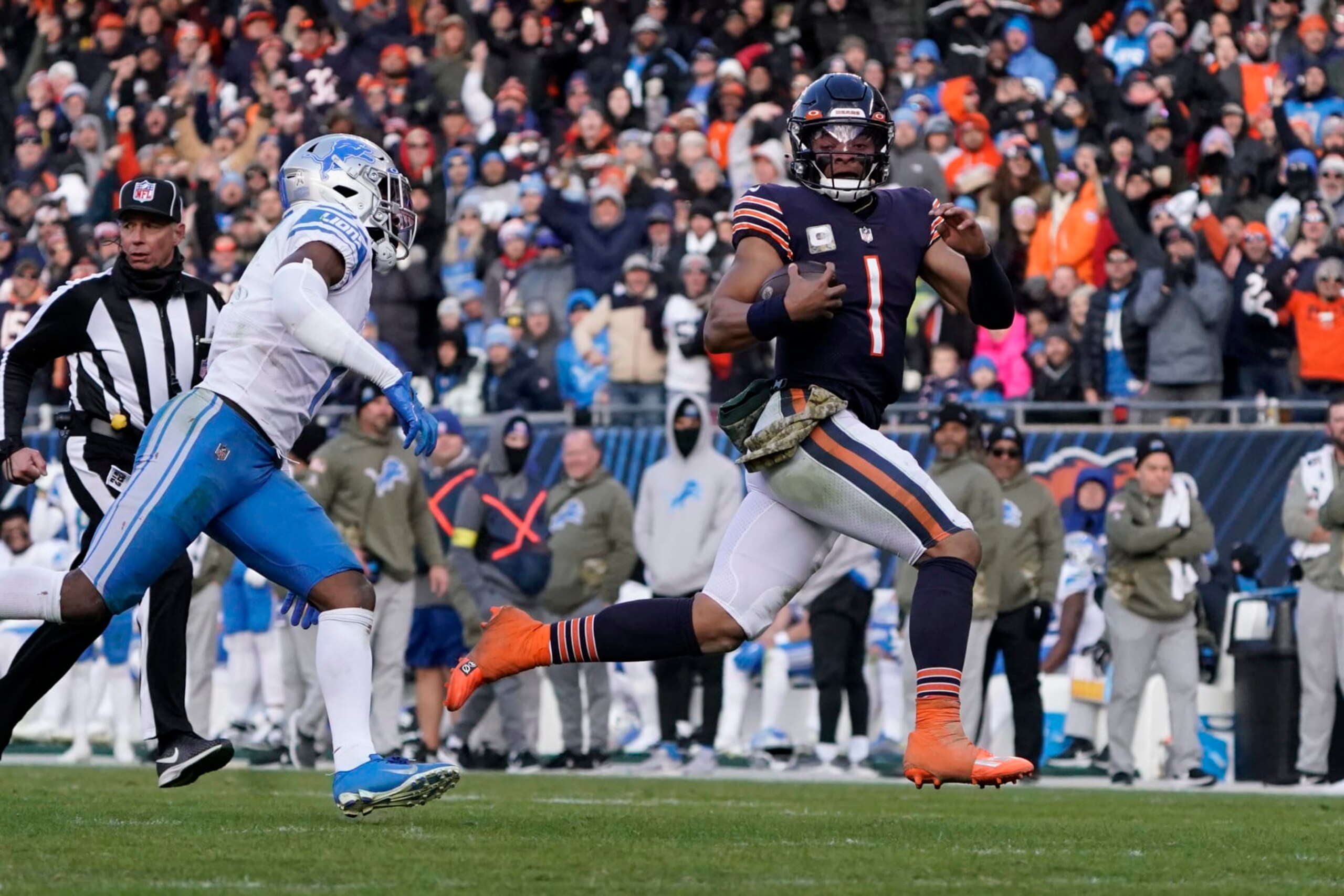Chicago Bears quarterback Justin Fields (1) runs for a sixty five yard touchdown against the Detroit Lions during the second half in an NFL football game Sunday, Nov. 13, 2022, in Chicago. (AP Photo/David Banks) Chicago Bears quarterback Justin Fields (1) runs for a sixty five yard touchdown against the Detroit Lions during the second half in an NFL football game Sunday, Nov. 13, 2022, in Chicago. (AP Photo/David Banks)