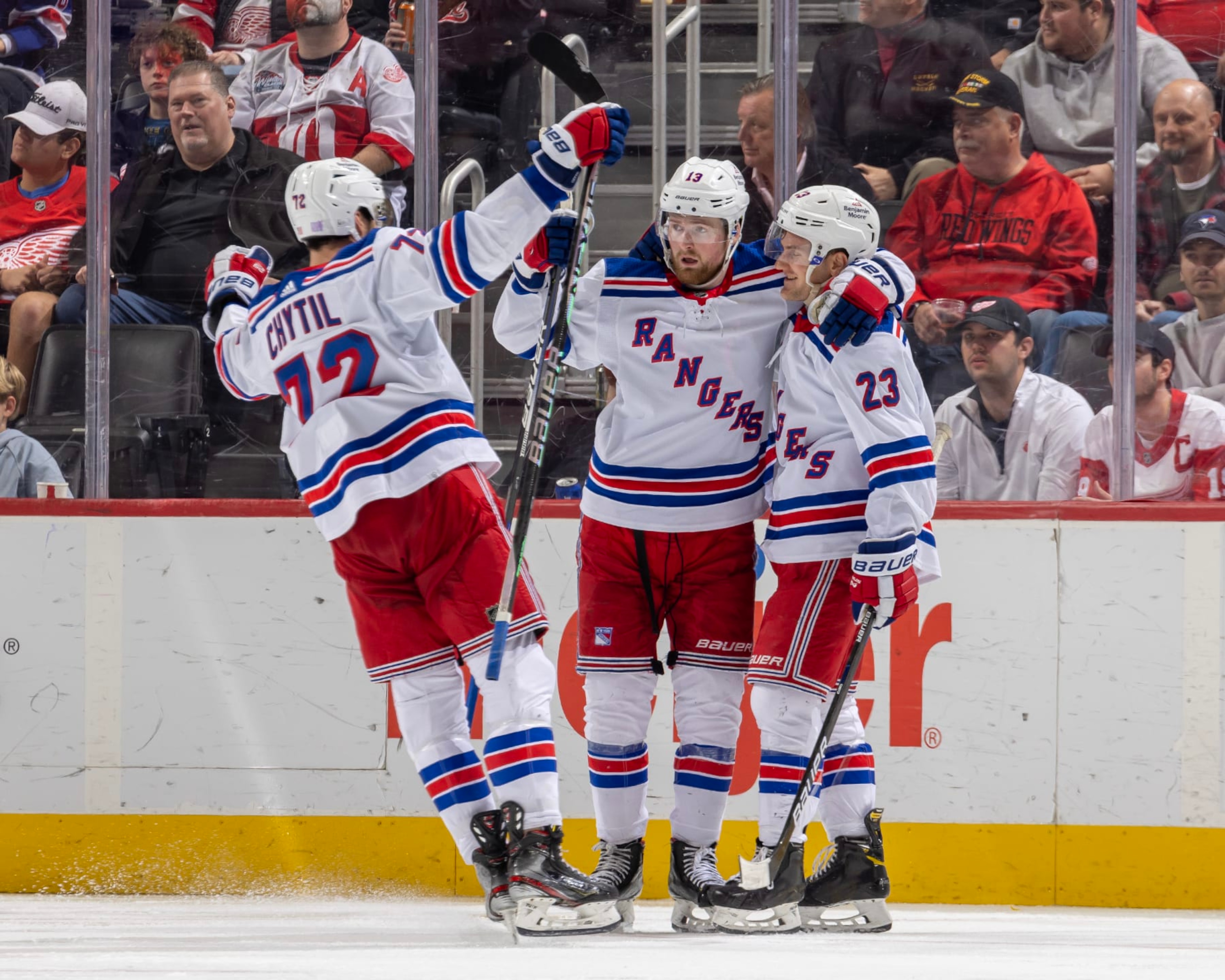 DETROIT, MI - NOVEMBER 10: Alexis Lafrenière #13 and Filip Chytil #72 of the New York Rangers congratulate teammate Adam Fox #23 after he scores a goal during the third period of an NHL game against the Detroit Red Wings at Little Caesars Arena on November 10, 2022 in Detroit, Michigan. New York defeated Detroit 8-2. (Photo by Dave Reginek/NHLI via Getty Images)