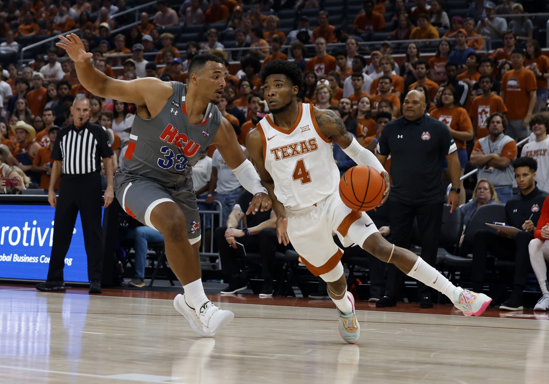 AUSTIN, TX - NOVEMBER 10: Texas Longhorns guard Tyrese Hunter drives to the hole past  Houston Baptist Huskies forward Sam Hofman during the game at the Moody Center in Austin, TX on November 10, 2022. (Photo by Adam Davis/Icon Sportswire via Getty Images)