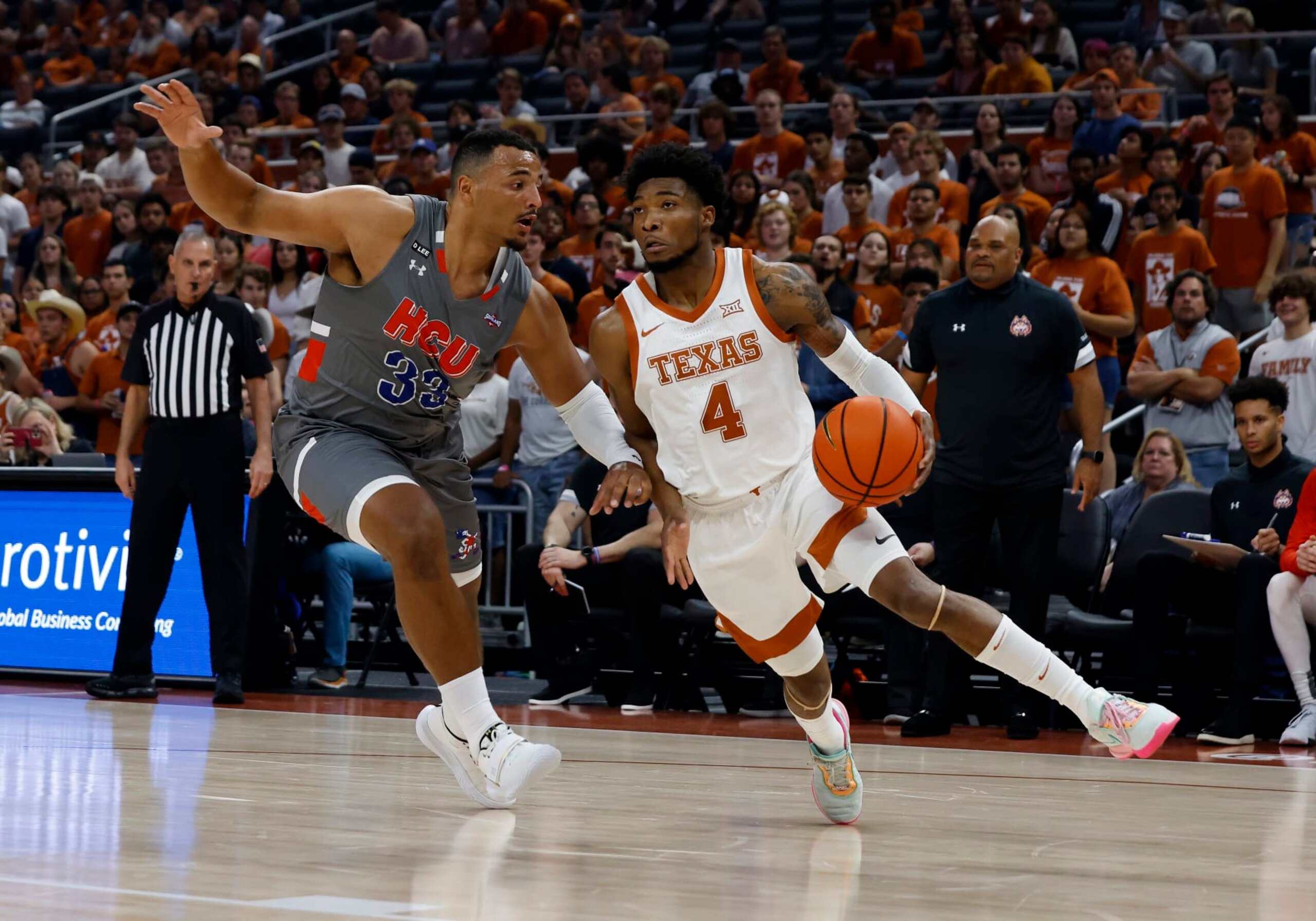 AUSTIN, TX - NOVEMBER 10: Texas Longhorns guard Tyrese Hunter drives to the hole past  Houston Baptist Huskies forward Sam Hofman during the game at the Moody Center in Austin, TX on November 10, 2022. (Photo by Adam Davis/Icon Sportswire via Getty Images)