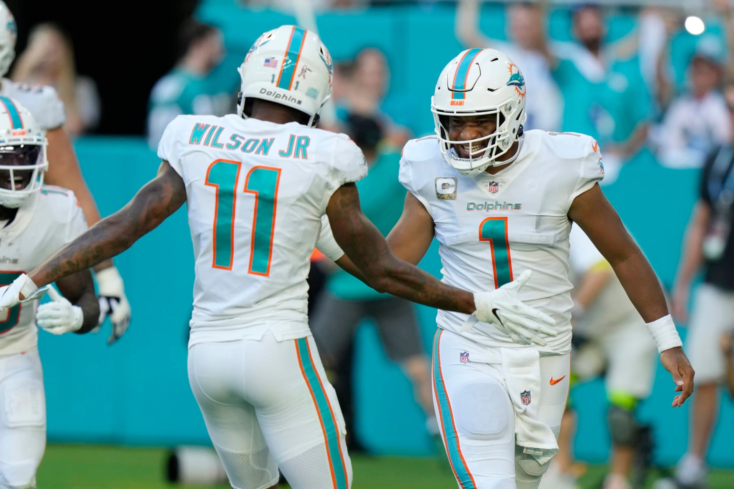 Miami Dolphins quarterback Tua Tagovailoa (1) celebrates a touchdown with wide receiver Cedrick Wilson Jr. (11) during the second half of an NFL football game, Sunday, Nov. 13, 2022, in Miami Gardens, Fla. (AP Photo/Wilfredo Lee)