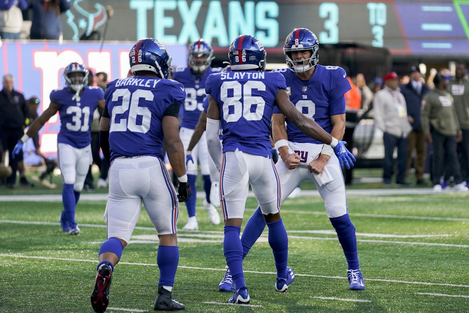 New York Giants quarterback Daniel Jones (8) celebrates with New York Giants wide receiver Darius Slayton (86) after Slayton scored a touchdown against the Houston Texans during the third quarter of an NFL football game, Sunday, Nov. 13, 2022, in East Rutherford, N.J. (AP Photo/Seth Wenig)