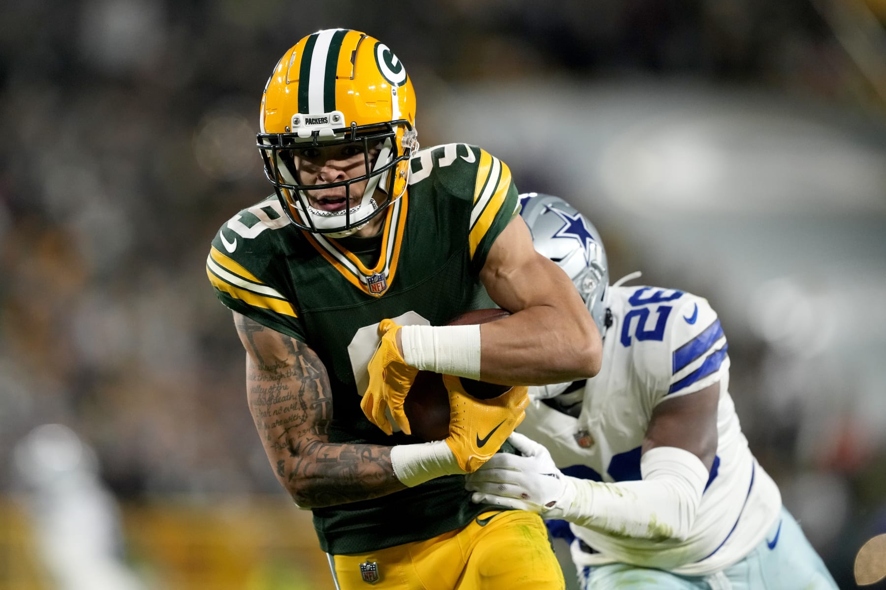 GREEN BAY, WISCONSIN - NOVEMBER 13: Christian Watson #9 of the Green Bay Packers catches a touchdown pass over DaRon Bland #26 of the Dallas Cowboys during the fourth quarter at Lambeau Field on November 13, 2022 in Green Bay, Wisconsin. (Photo by Patrick McDermott/Getty Images)