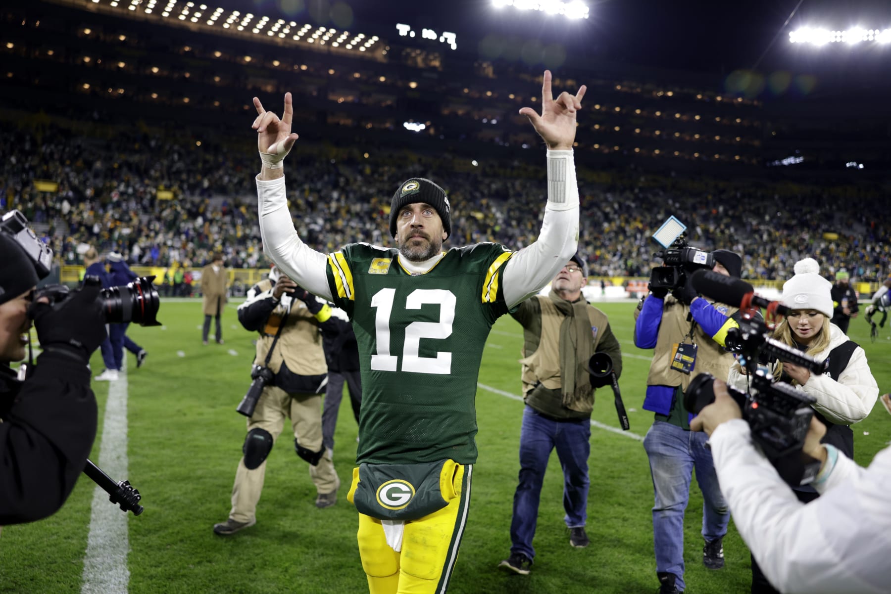 Green Bay Packers quarterback Aaron Rodgers (12) celebrates as he walks off the field following the team's 31-28 overtime win in an NFL football game against the Dallas Cowboys Sunday, Nov. 13, 2022, in Green Bay, Wis. (AP Photo/Matt Ludtke)