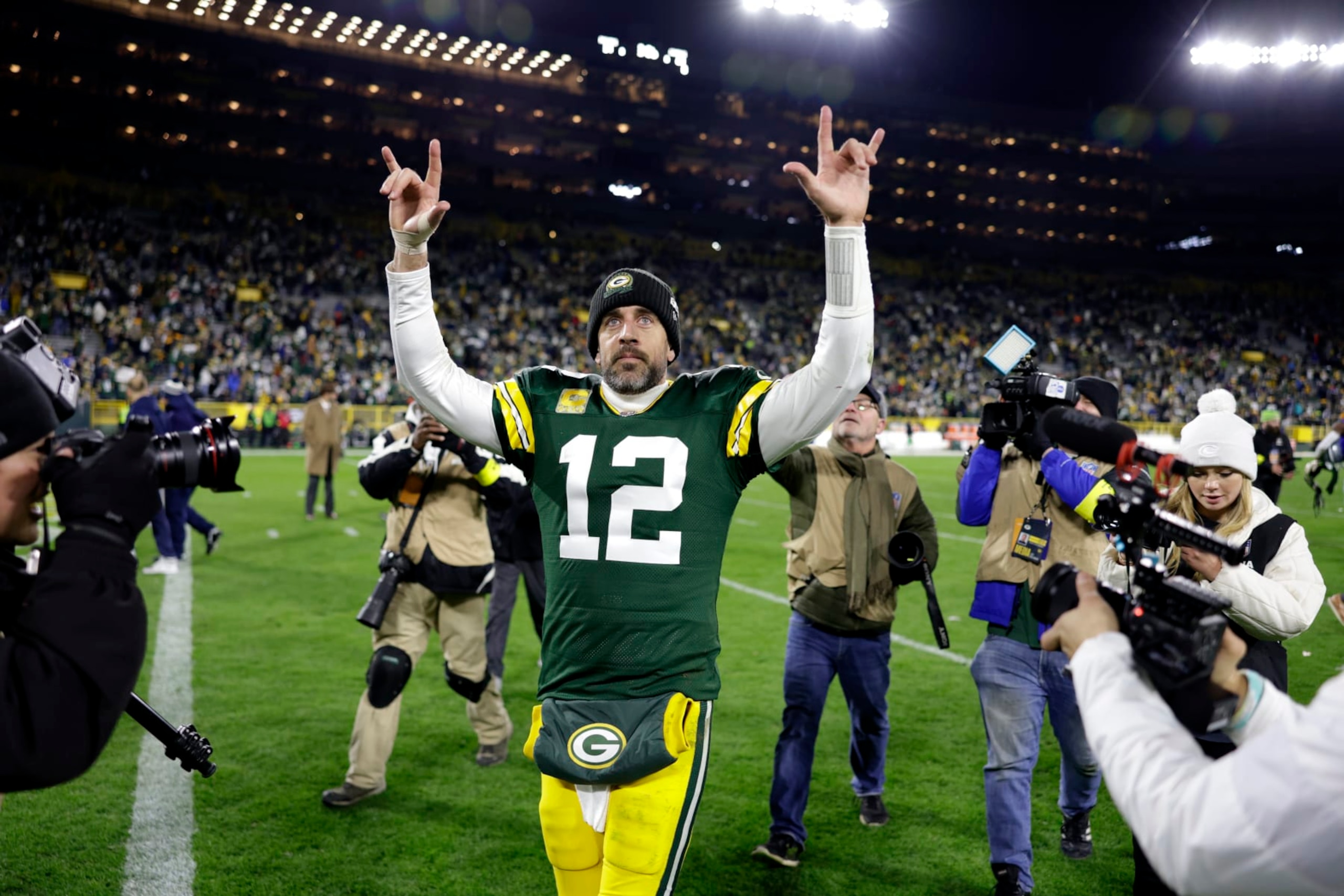 Green Bay Packers quarterback Aaron Rodgers (12) celebrates as he walks off the field following the team's 31-28 overtime win in an NFL football game against the Dallas Cowboys Sunday, Nov. 13, 2022, in Green Bay, Wis. (AP Photo/Matt Ludtke)