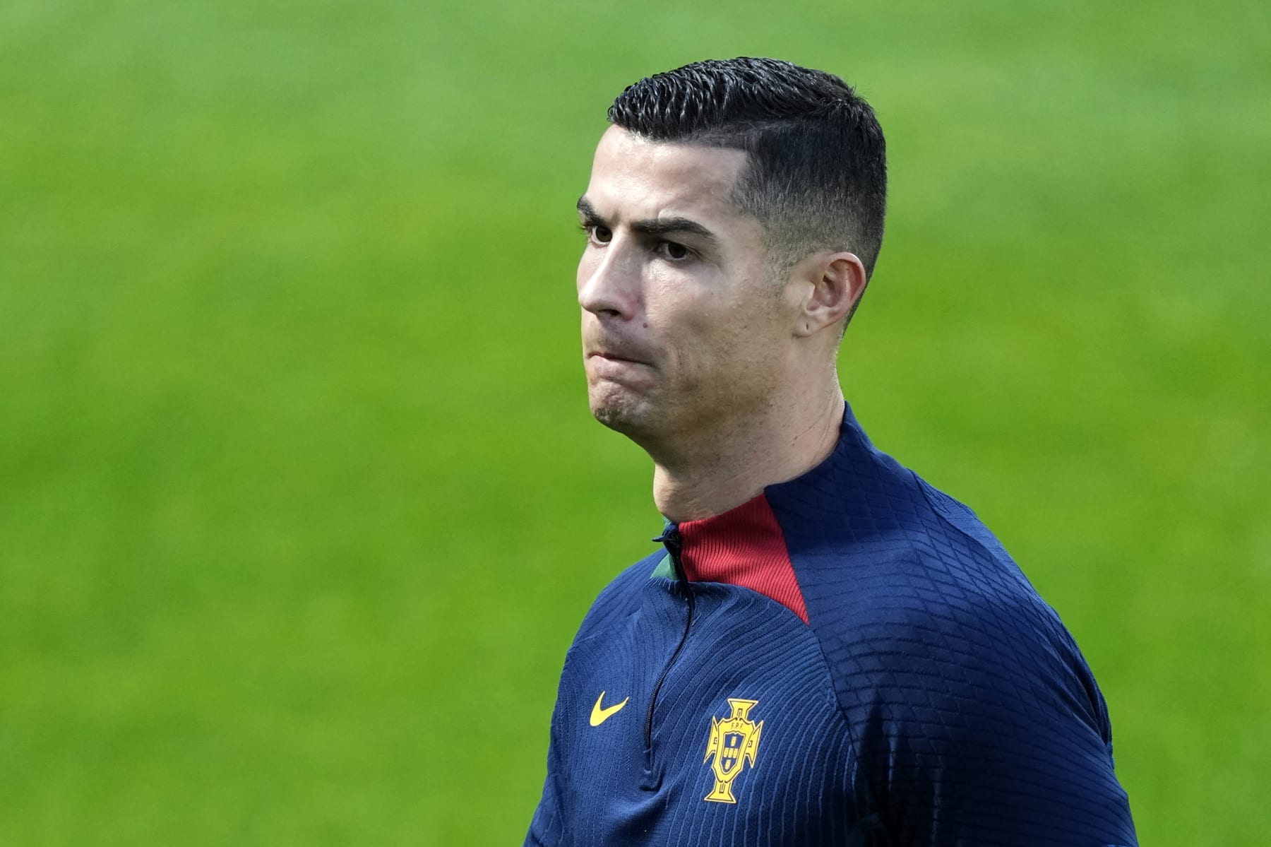 Cristiano Ronaldo walks on the pitch during a Portugal soccer team training in Oeiras, outside Lisbon, Monday, Nov. 14, 2022. Portugal will play Nigeria Thursday in a friendly match in Lisbon before departing to Qatar on Friday for the World Cup. (AP Photo/Armando Franca)