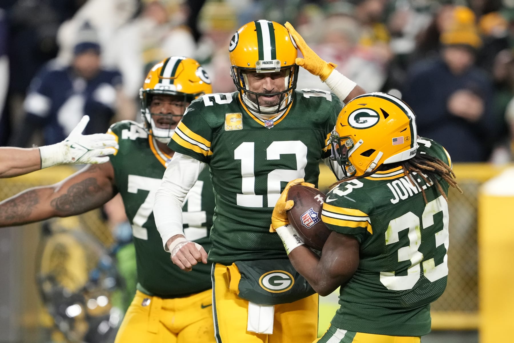 GREEN BAY, WISCONSIN - NOVEMBER 13: Aaron Rodgers #12 of the Green Bay Packers celebrates with Aaron Jones #33 of the Green Bay Packers after Jones' touchdown during the second quarter against the Dallas Cowboys at Lambeau Field on November 13, 2022 in Green Bay, Wisconsin. (Photo by Patrick McDermott/Getty Images)