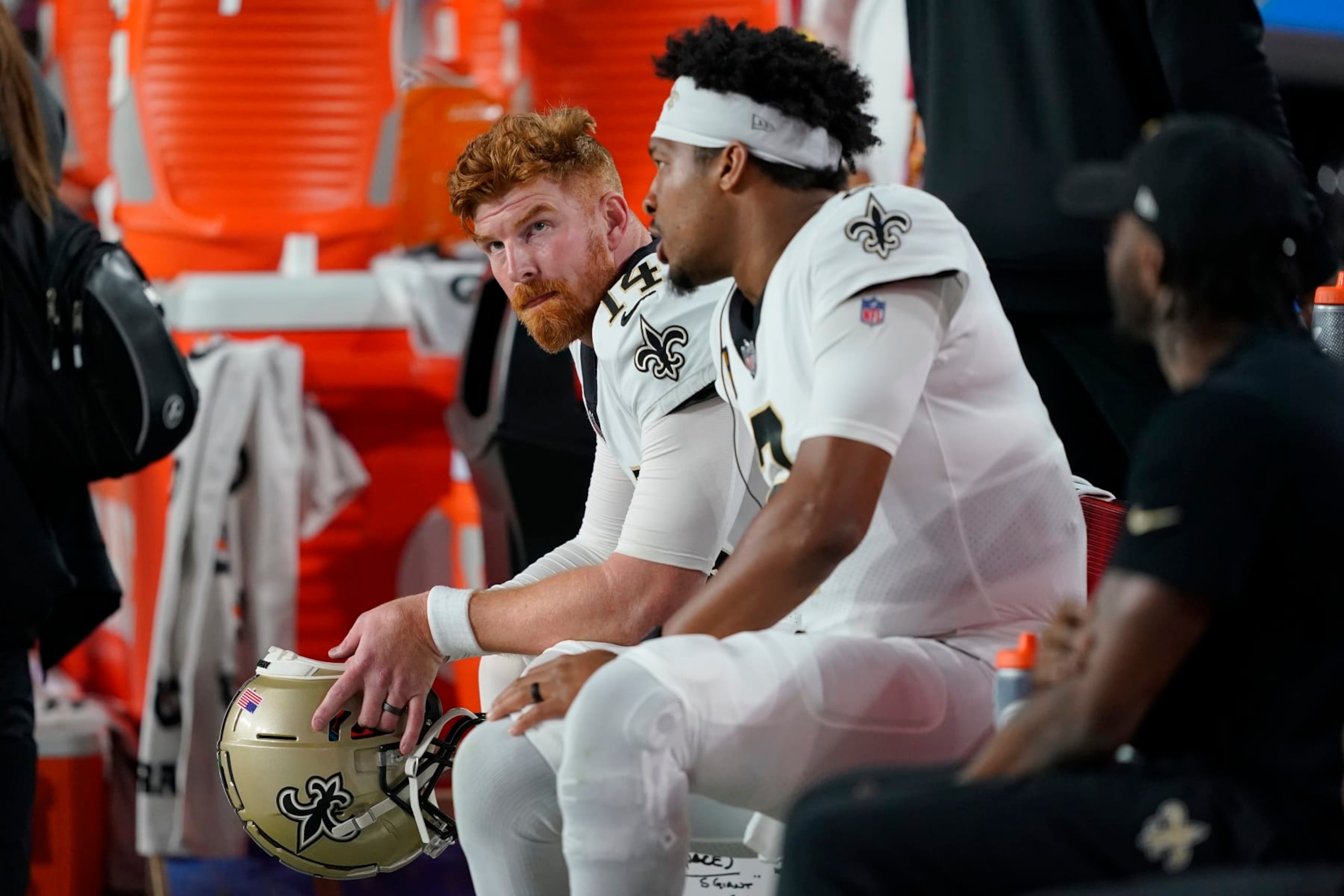 New Orleans Saints quarterback Andy Dalton, left, and quarterback Jameis Winston watch during the second half of an NFL football game against the Arizona Cardinals, Thursday, Oct. 20, 2022, in Glendale, Ariz. (AP Photo/Matt York)
