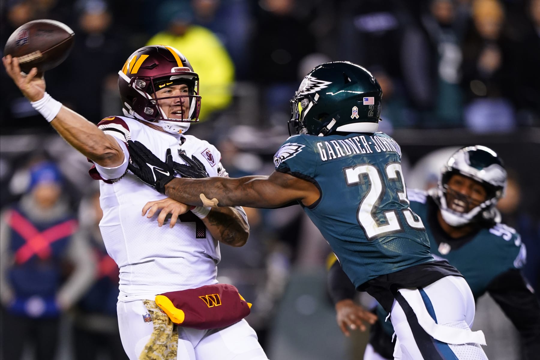 Washington Commanders quarterback Taylor Heinicke (4) throws under pressure by Philadelphia Eagles safety C.J. Gardner-Johnson (23) during the second half of an NFL football game, Monday, Nov. 14, 2022, in Philadelphia. (AP Photo/Chris Szagola)
