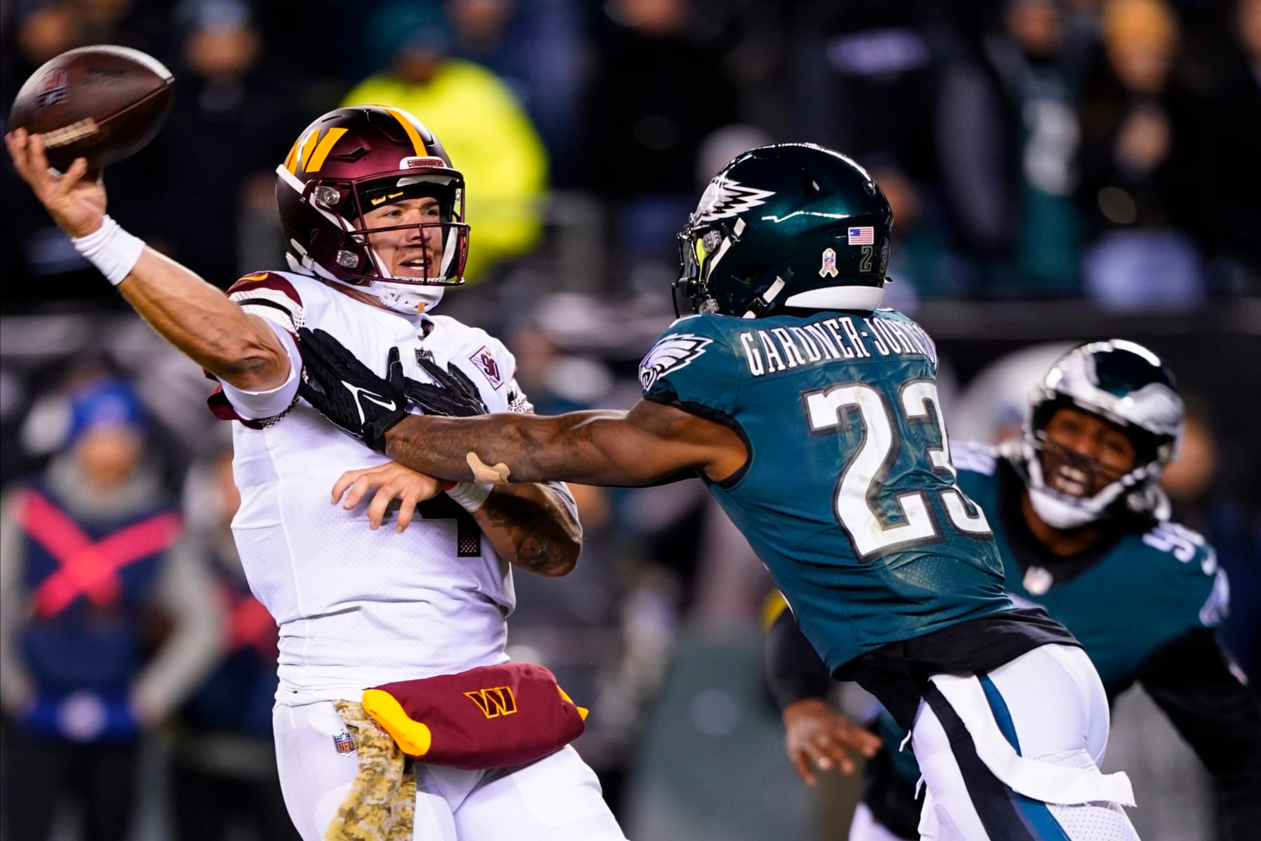 Washington Commanders quarterback Taylor Heinicke (4) throws under pressure by Philadelphia Eagles safety C.J. Gardner-Johnson (23) during the second half of an NFL football game, Monday, Nov. 14, 2022, in Philadelphia. (AP Photo/Chris Szagola)