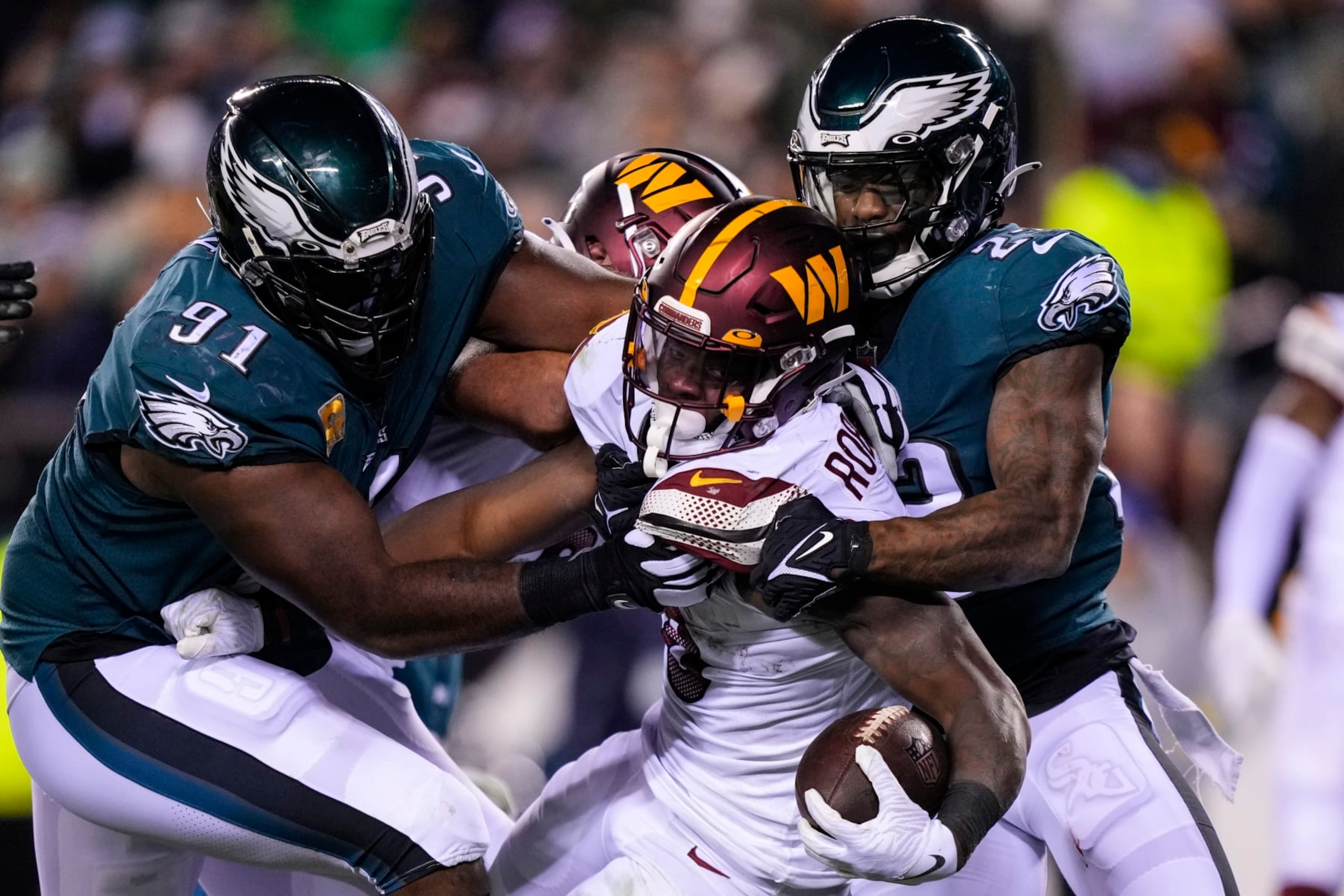 Washington Commanders running back Brian Robinson Jr. (8) runs into the end zone against Philadelphia Eagles defensive tackle Fletcher Cox (91) and Philadelphia Eagles safety C.J. Gardner-Johnson (23) during the first half of an NFL football game, Monday, Nov. 14, 2022, in Philadelphia. (AP Photo/Matt Slocum)