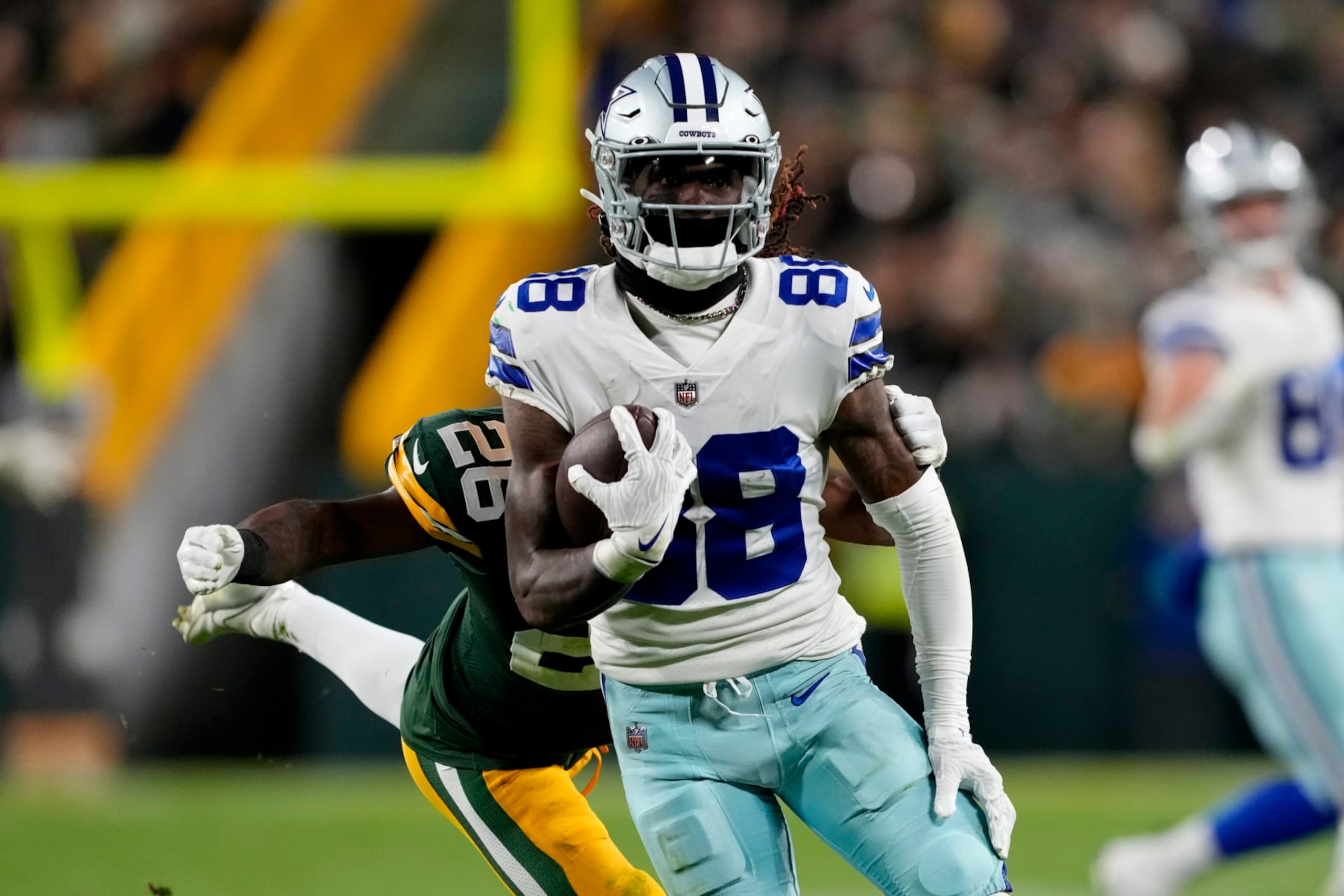 GREEN BAY, WISCONSIN - NOVEMBER 13: Darnell Savage #26 of the Green Bay Packers tackles CeeDee Lamb #88 of the Dallas Cowboys during the third quarter at Lambeau Field on November 13, 2022 in Green Bay, Wisconsin. (Photo by Patrick McDermott/Getty Images)