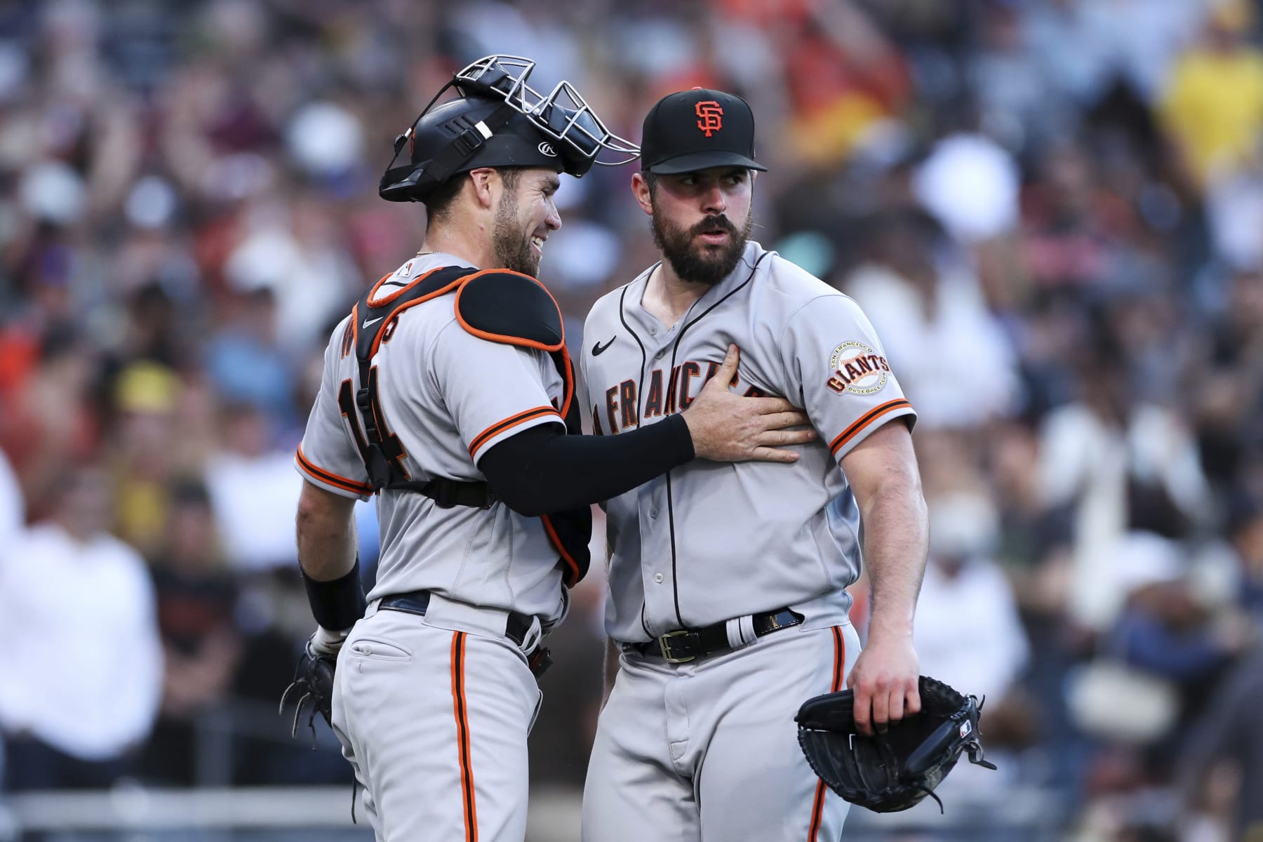 San Francisco Giants starting pitcher Carlos Rodon, right, is congratulated by catcher Austin Wynns after the team defeated the San Diego Padres in a baseball game Saturday, July 9, 2022, in San Diego. (AP Photo/Derrick Tuskan)