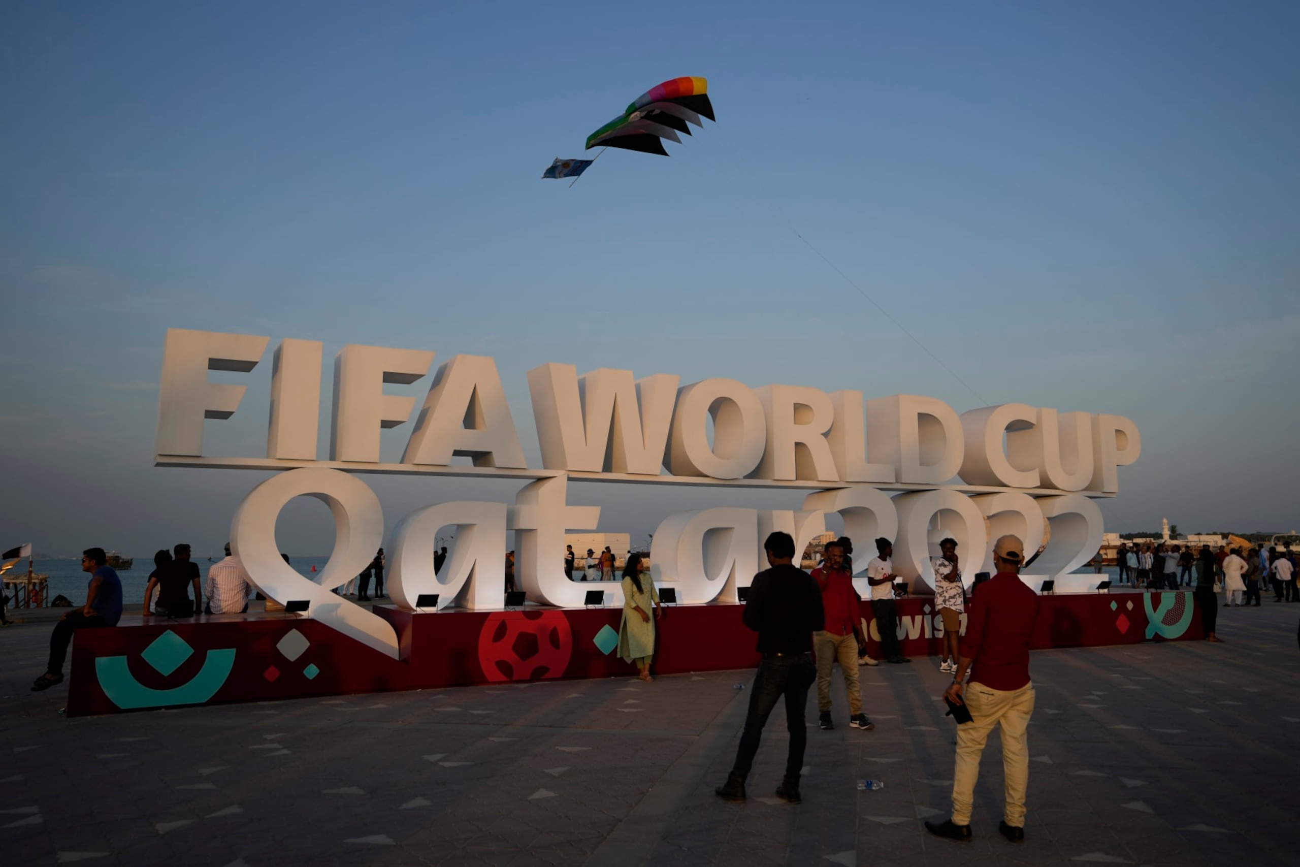 People pose for a photograph with a sign reading in English" Fifa World Cup, Qatar 2022" at the corniche in Doha, Qatar, Friday, Nov. 11, 2022. Final preparations are being made for the soccer World Cup which starts on Nov. 20 when Qatar face Ecuador. (AP Photo/Hassan Ammar) People pose for a photograph with a sign reading in English" Fifa World Cup, Qatar 2022" at the corniche in Doha, Qatar, Friday, Nov. 11, 2022. Final preparations are being made for the soccer World Cup which starts on Nov. 20 when Qatar face Ecuador. (AP Photo/Hassan Ammar)